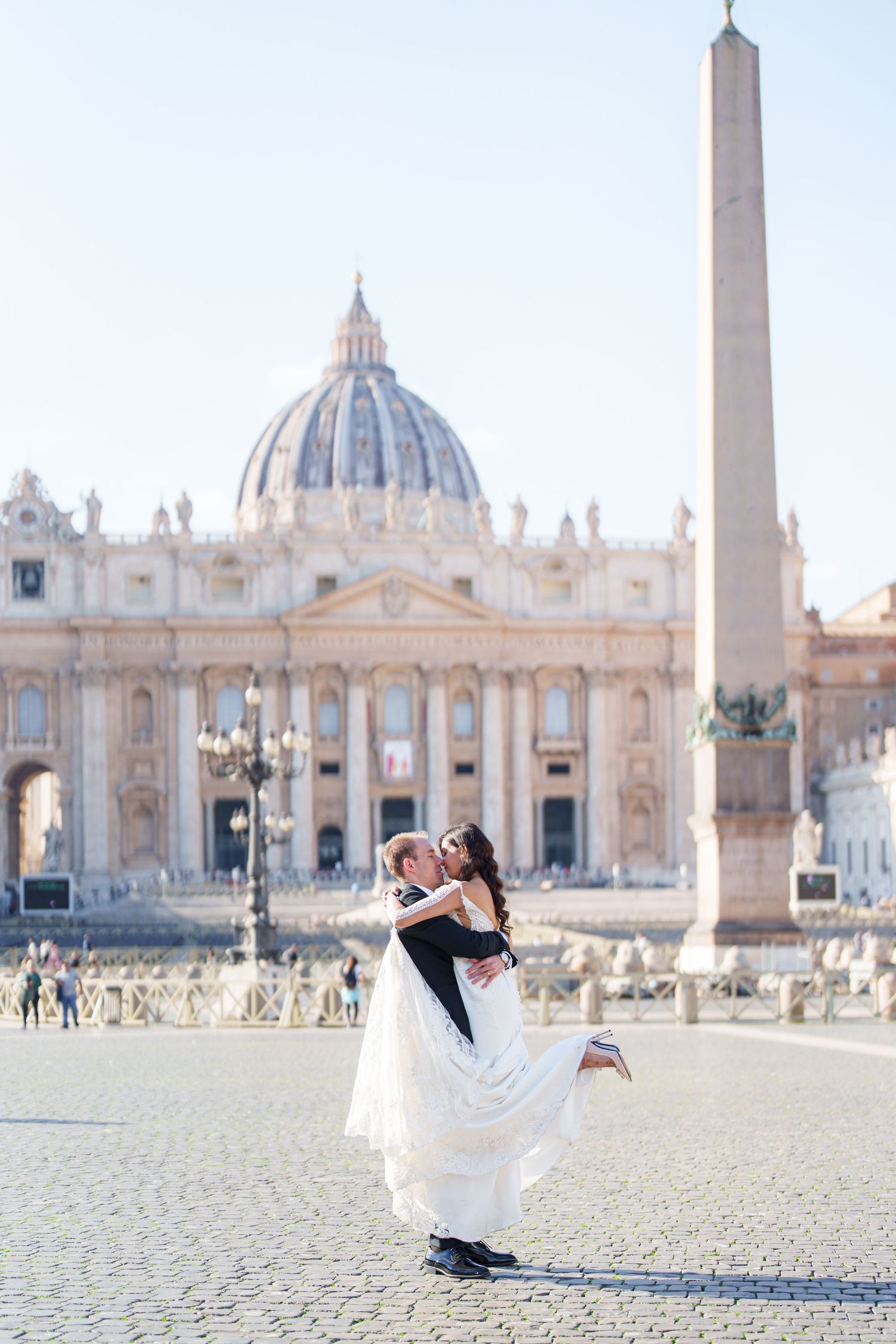 Romantic couple portraits captured in the expansive St. Peter's Square with the historic Vatican architecture.