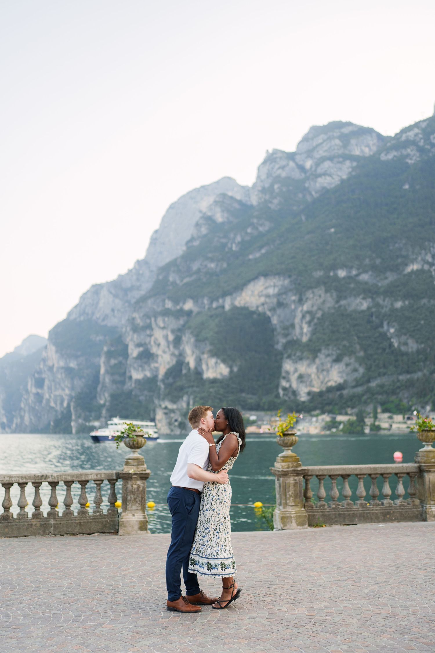 Couple portrait by Lake Garda surrounded by mountains in Riva del Garda, Italy
