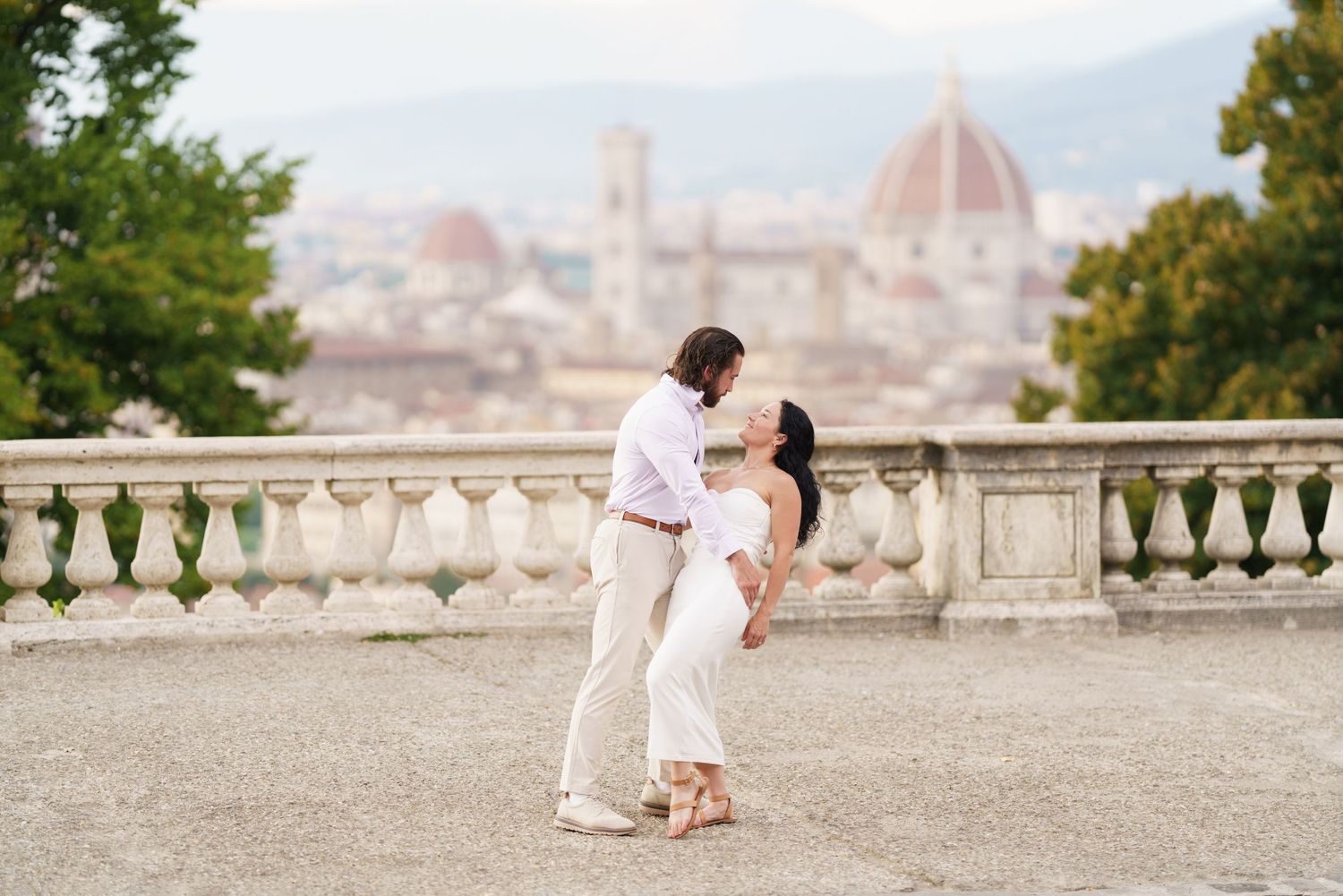 A romantic photoshoot overlooking the beautiful cityscape of Florence, Italy with the iconic Duomo dome in the background.