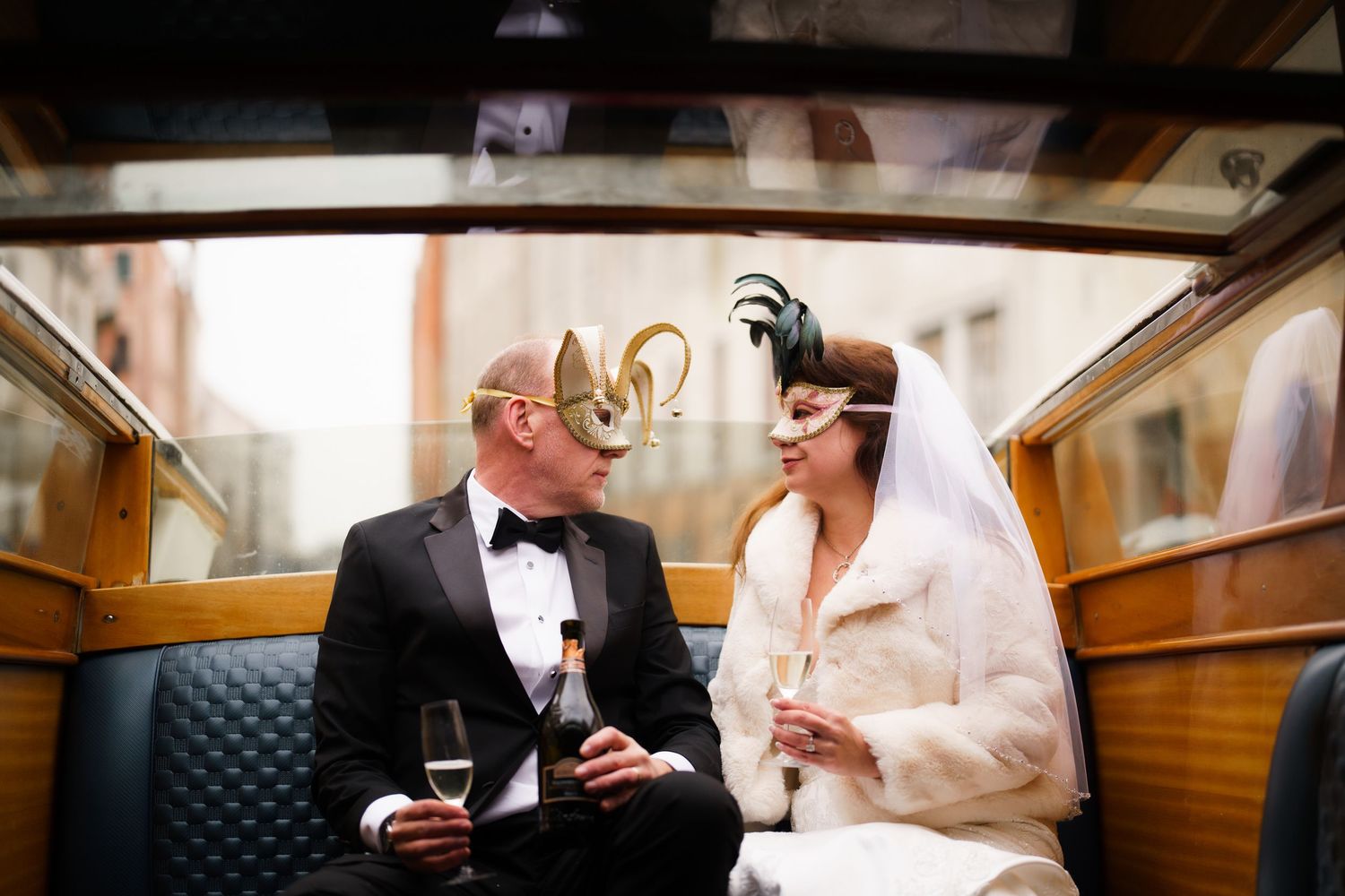Bride and groom share intimate moments in a luxury train car during their wedding photoshoot.
