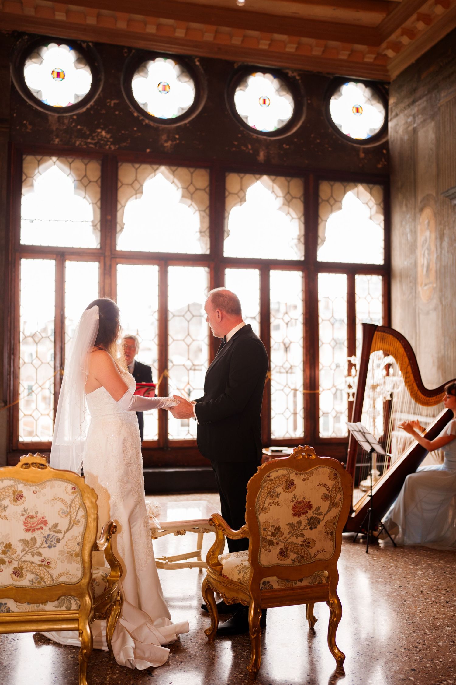 A romantic wedding sequence showing silhouettes of a couple in an elegant room with vintage furniture and ornate windows.