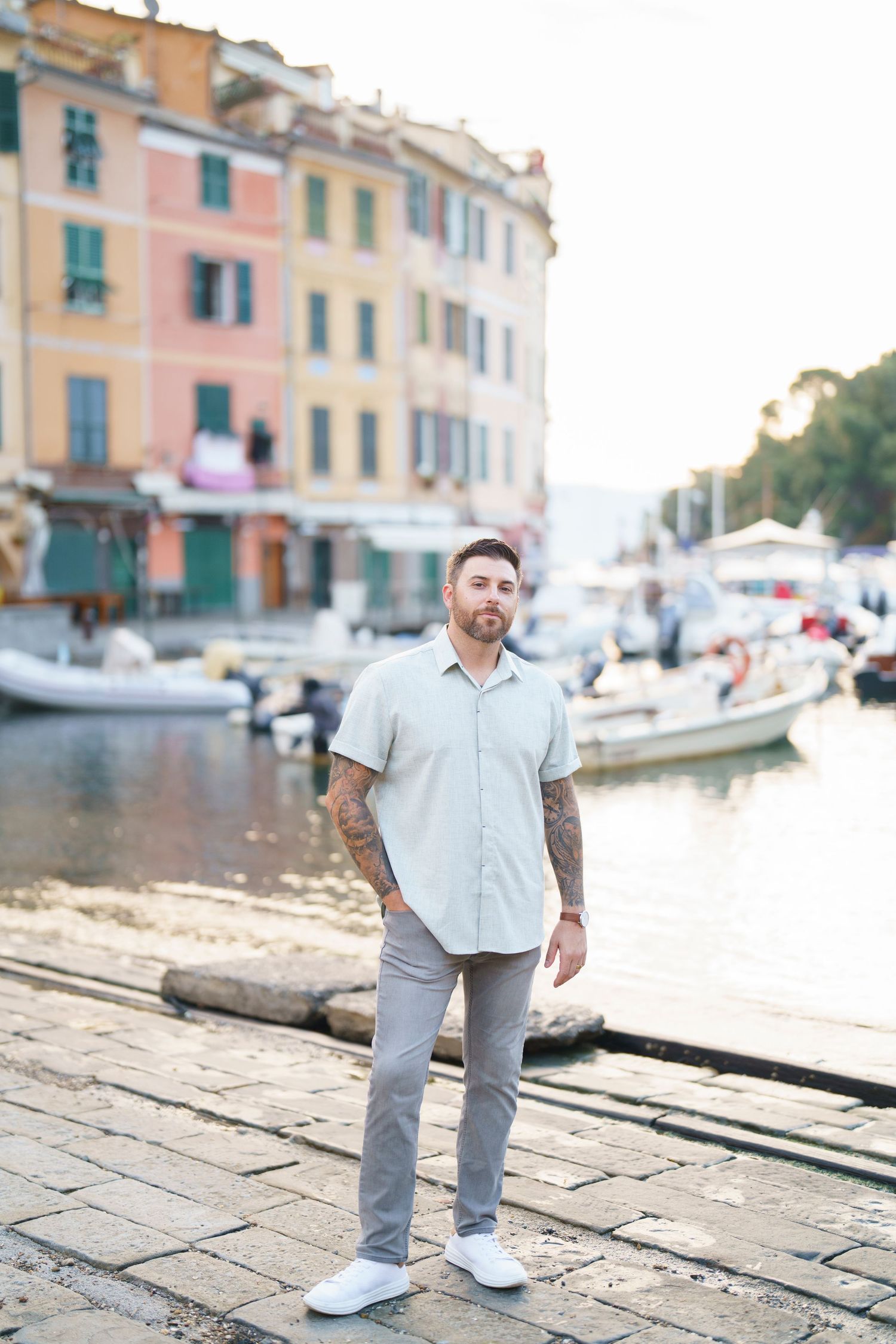 Scenic waterfront view in Portofino Italy with colorful buildings and boats docked along the harbor.