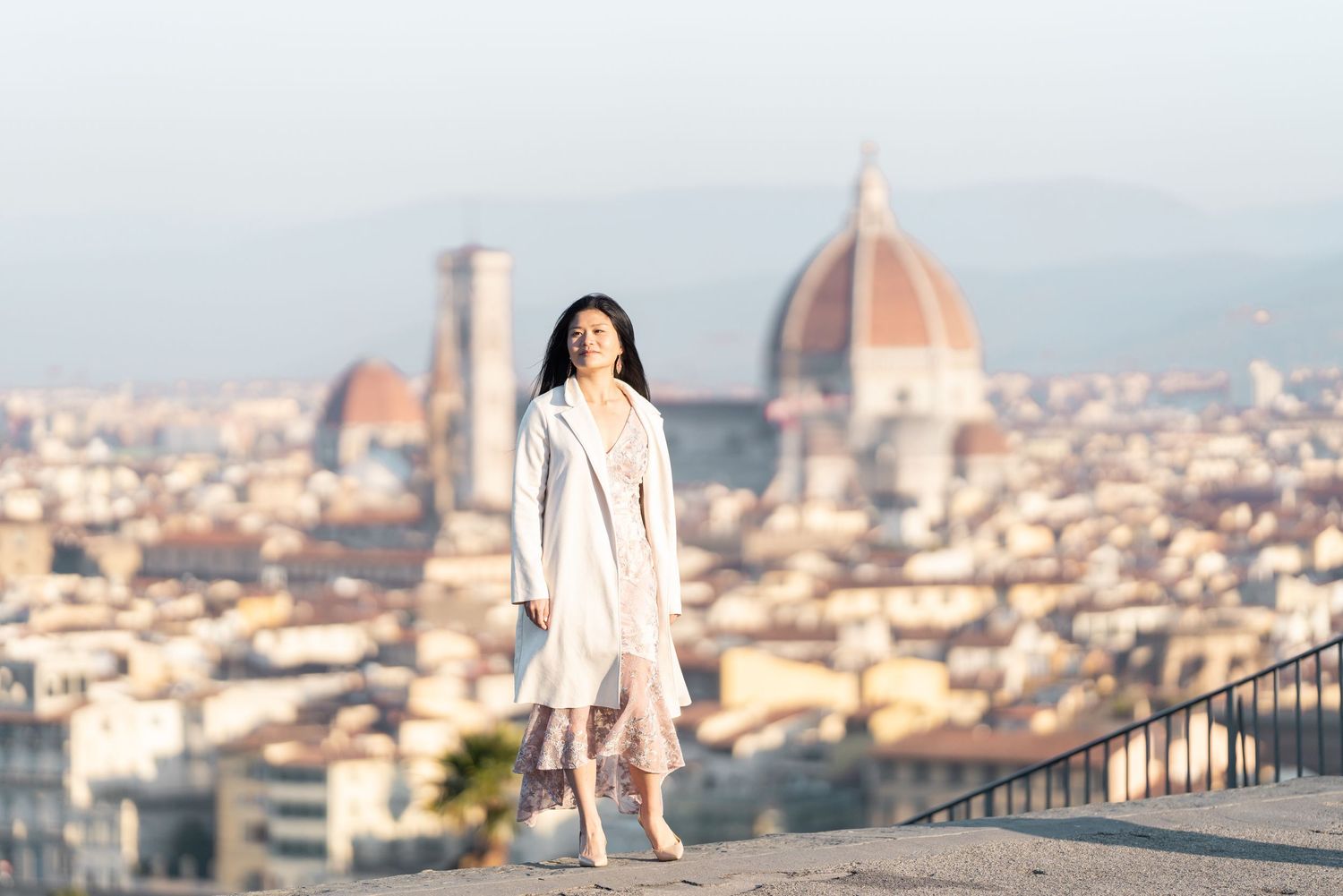 A scenic view of Florence, Italy with the iconic Duomo cathedral dome and cityscape visible in the background.
