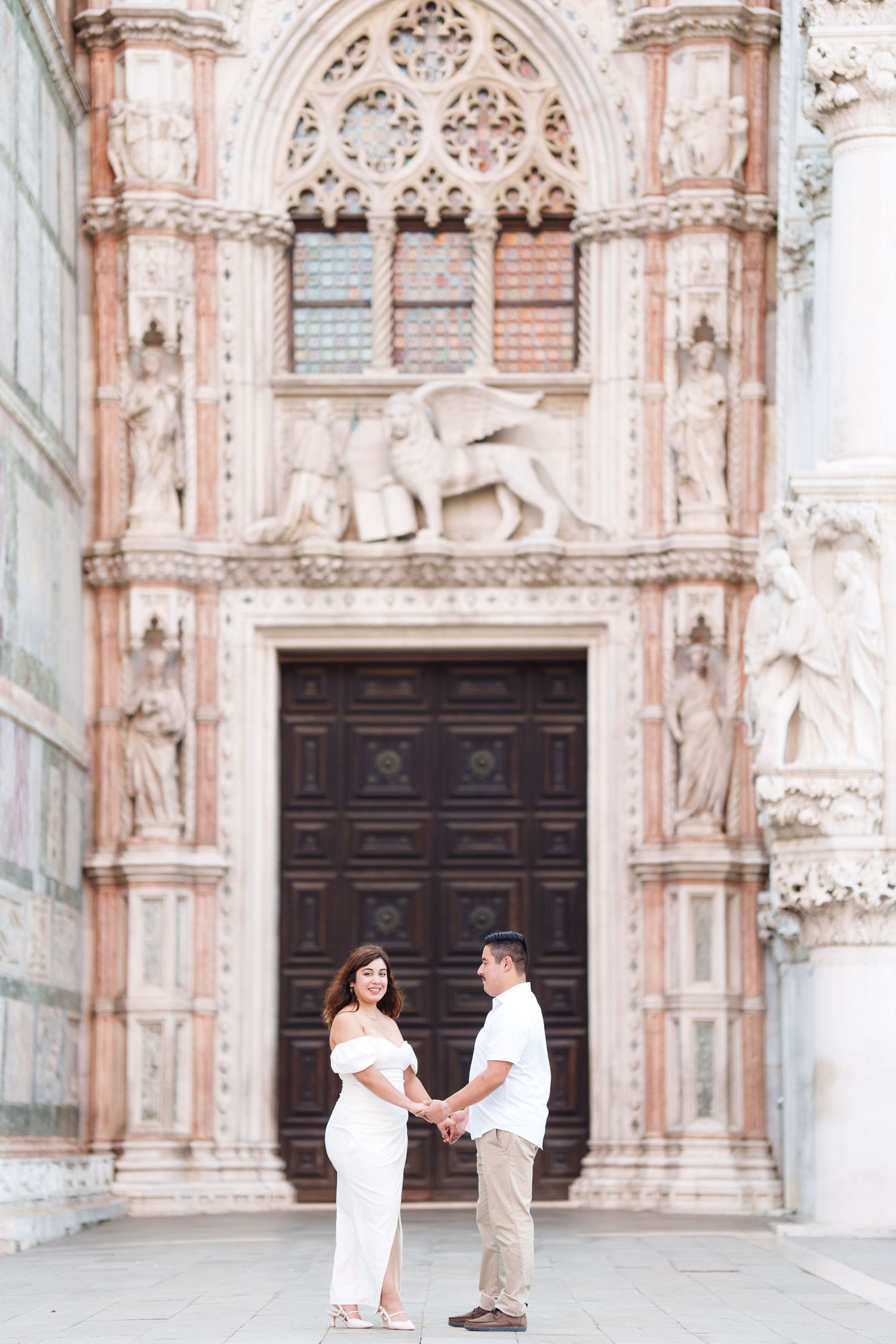 A romantic proposal scene in front of an ornate Gothic cathedral with intricate stone carvings and architectural details.