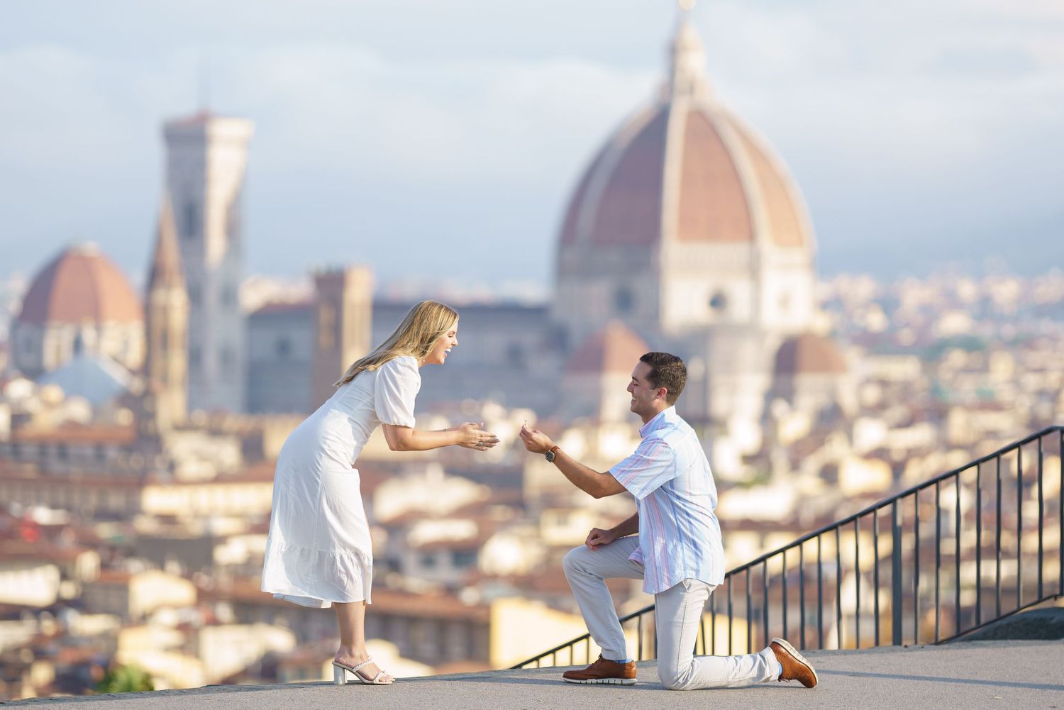 A romantic proposal moment overlooking Florence, Italy with the iconic Duomo cathedral dome in the background.