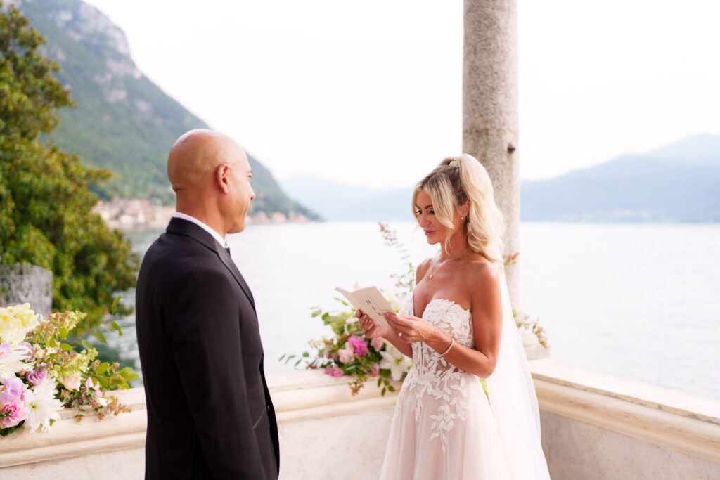 Intimate wedding ceremony on lakeside terrace with mountain views.