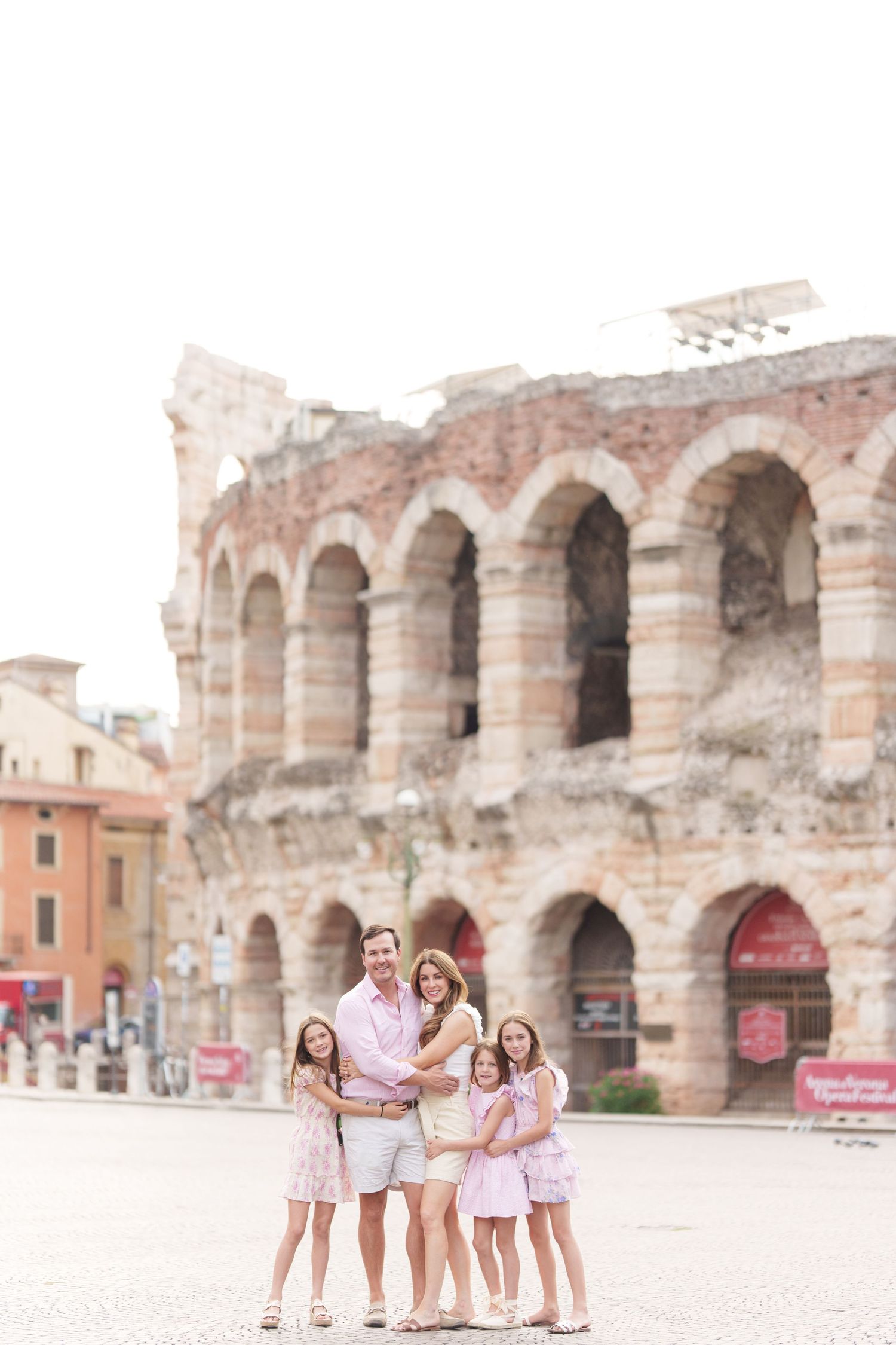 Verona family photographer family walking in front of Verona Arena Italy