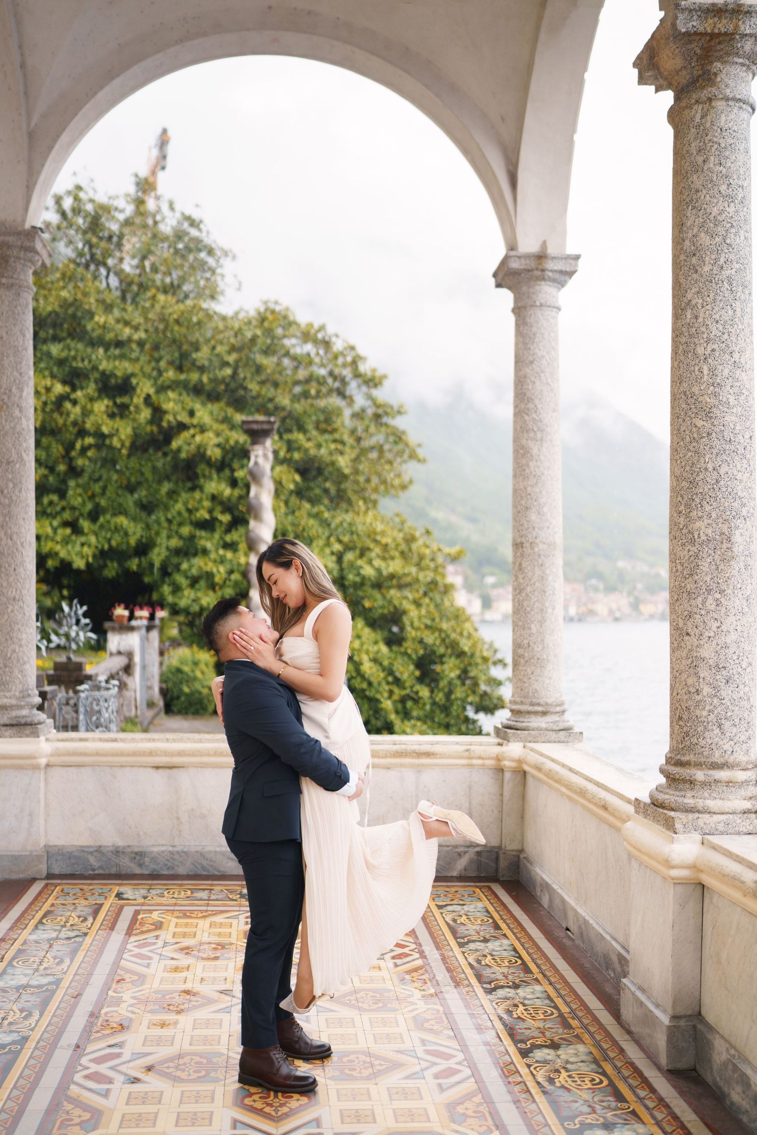 Lake Como proposal photographer capturing surprise engagement at Villa Monastero in Varenna