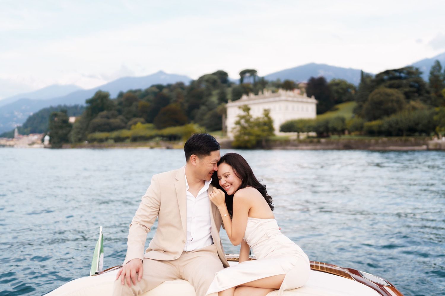 A romantic couple shares tender moments during their seaside engagement photo session at a scenic coastal location.
