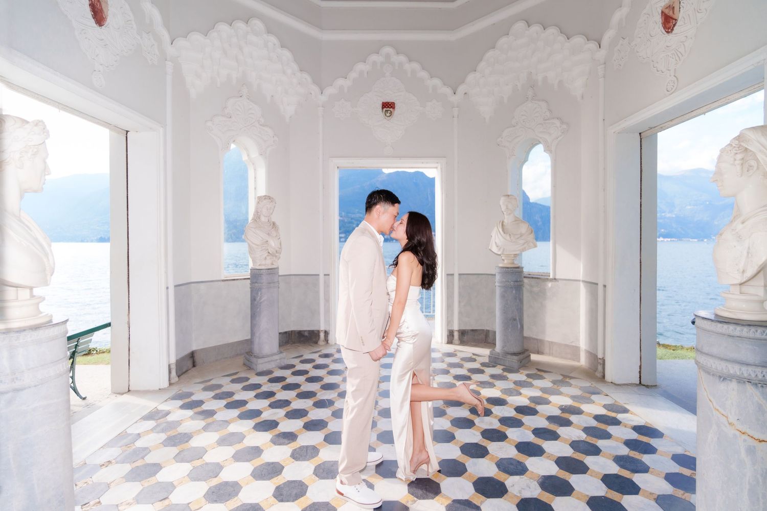Elegant white marble colonnade with blue and white checkered floor tiles creates a stunning architectural perspective.