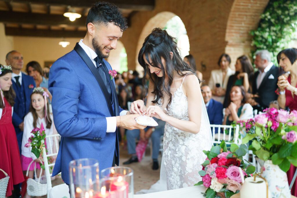Wedding celebration in a rustic venue with guests mingling under wooden beams.
