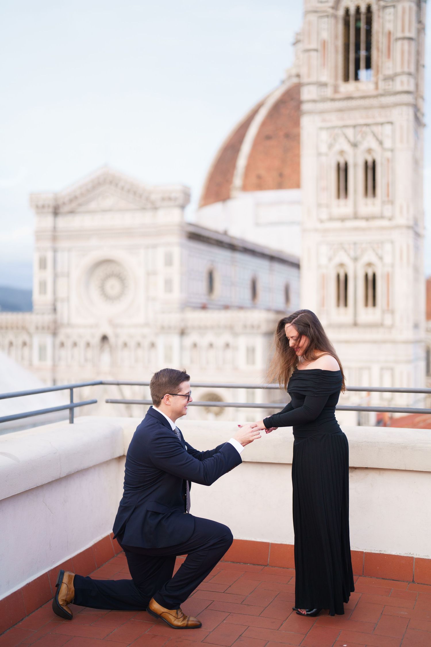 A series of proposal photos showing a couple on a rooftop terrace with Florence Cathedral's dome in the background.