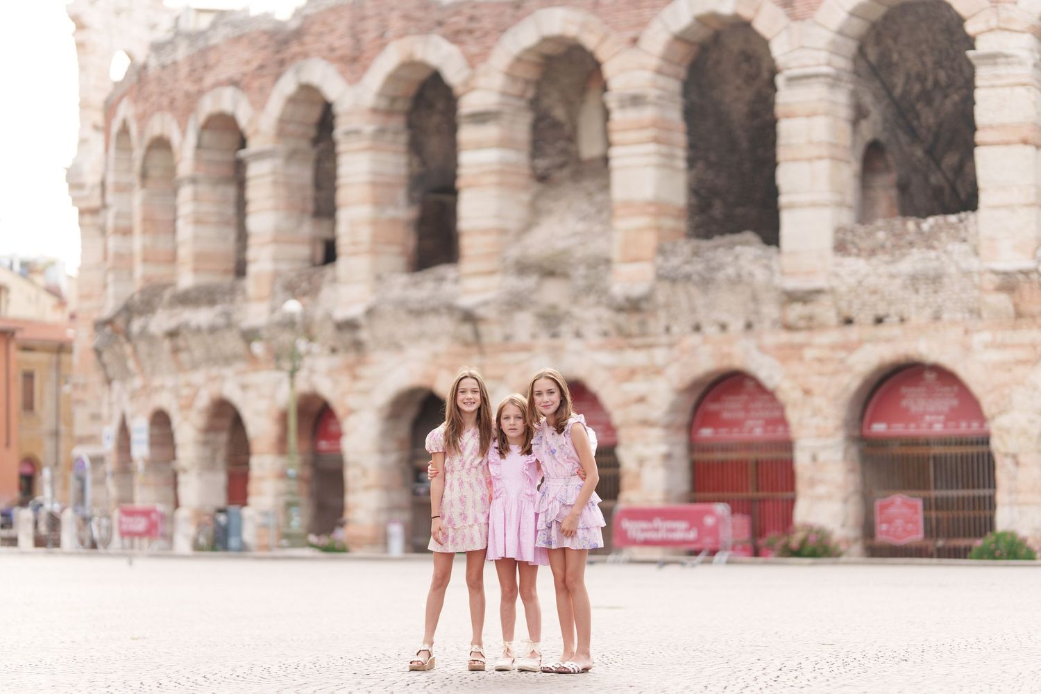 Verona family photographer family walking in front of Verona Arena Italy
