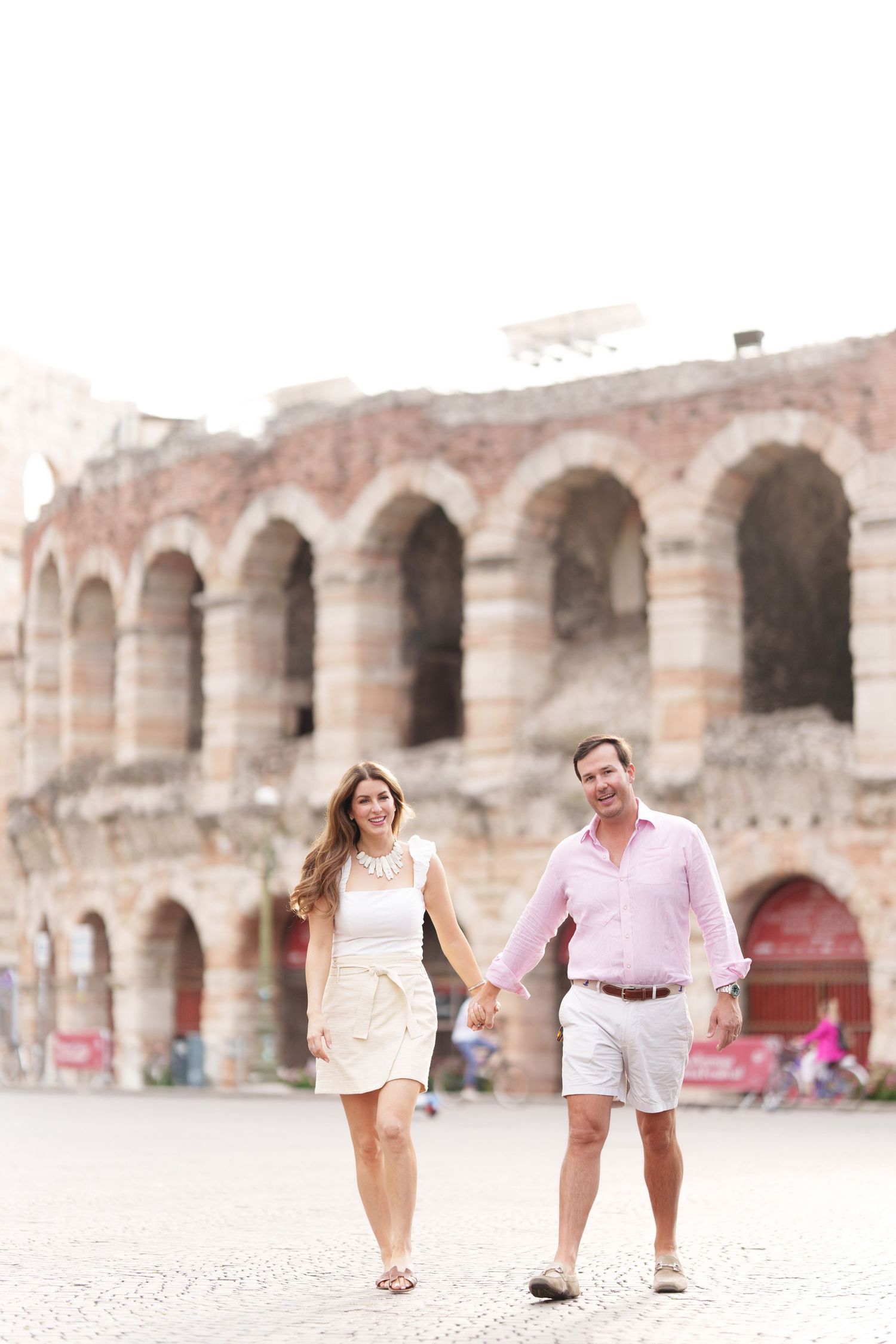 Verona family photographer family walking in front of Verona Arena Italy