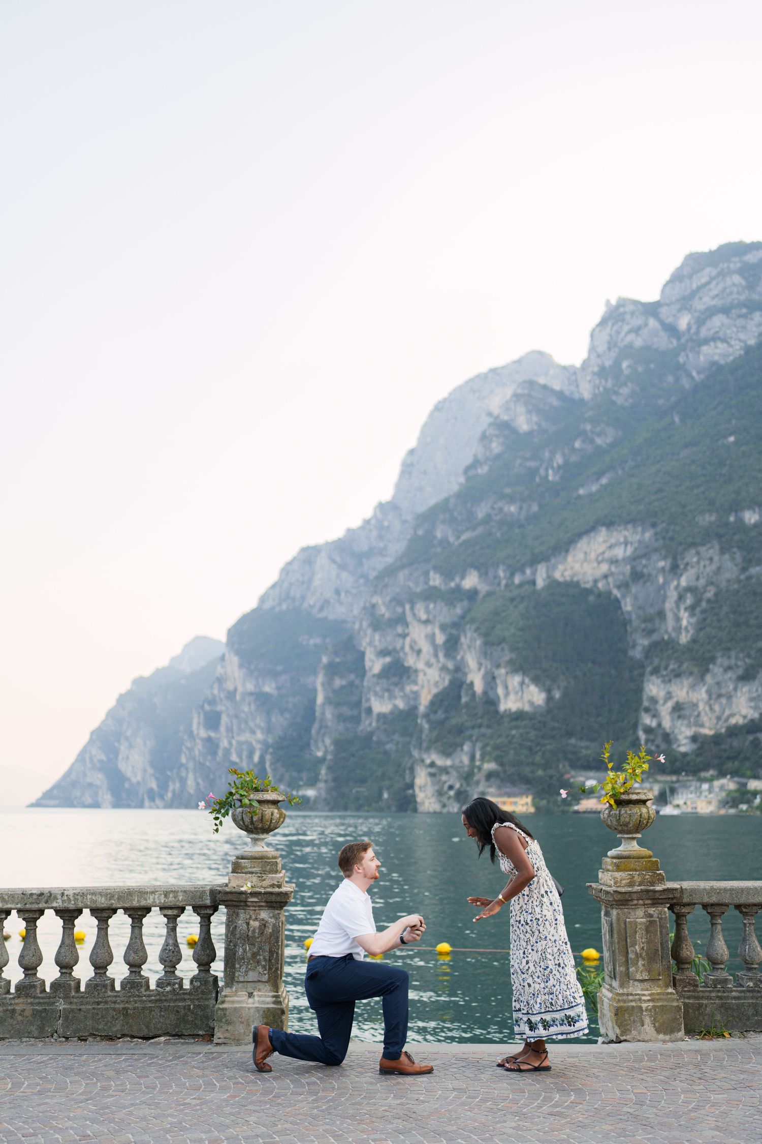 Surprise marriage proposal on one knee overlooking Lake Garda in Riva del Garda, Italy