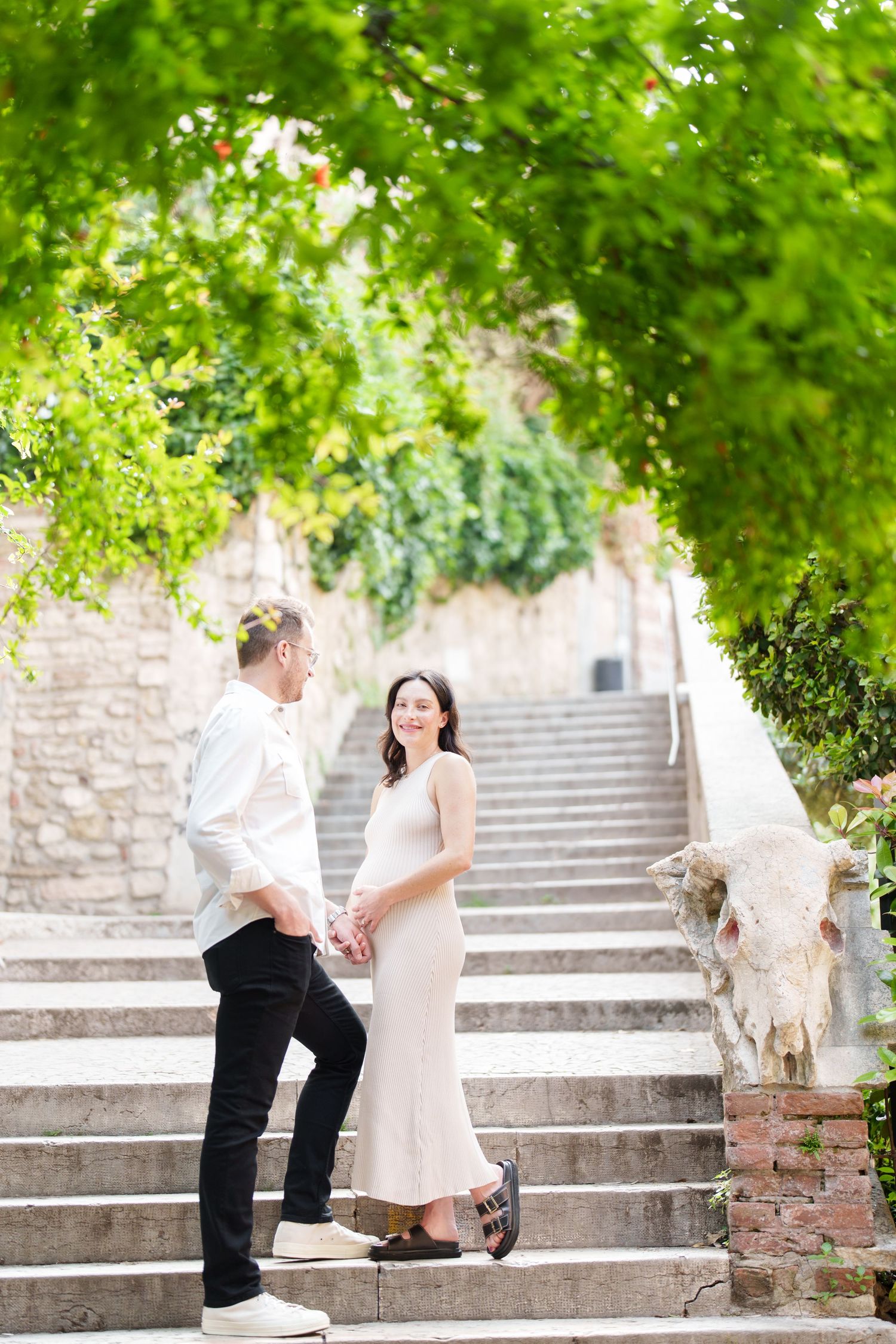A sequence of romantic photos showing a couple proposing on stone steps surrounded by lush green foliage.