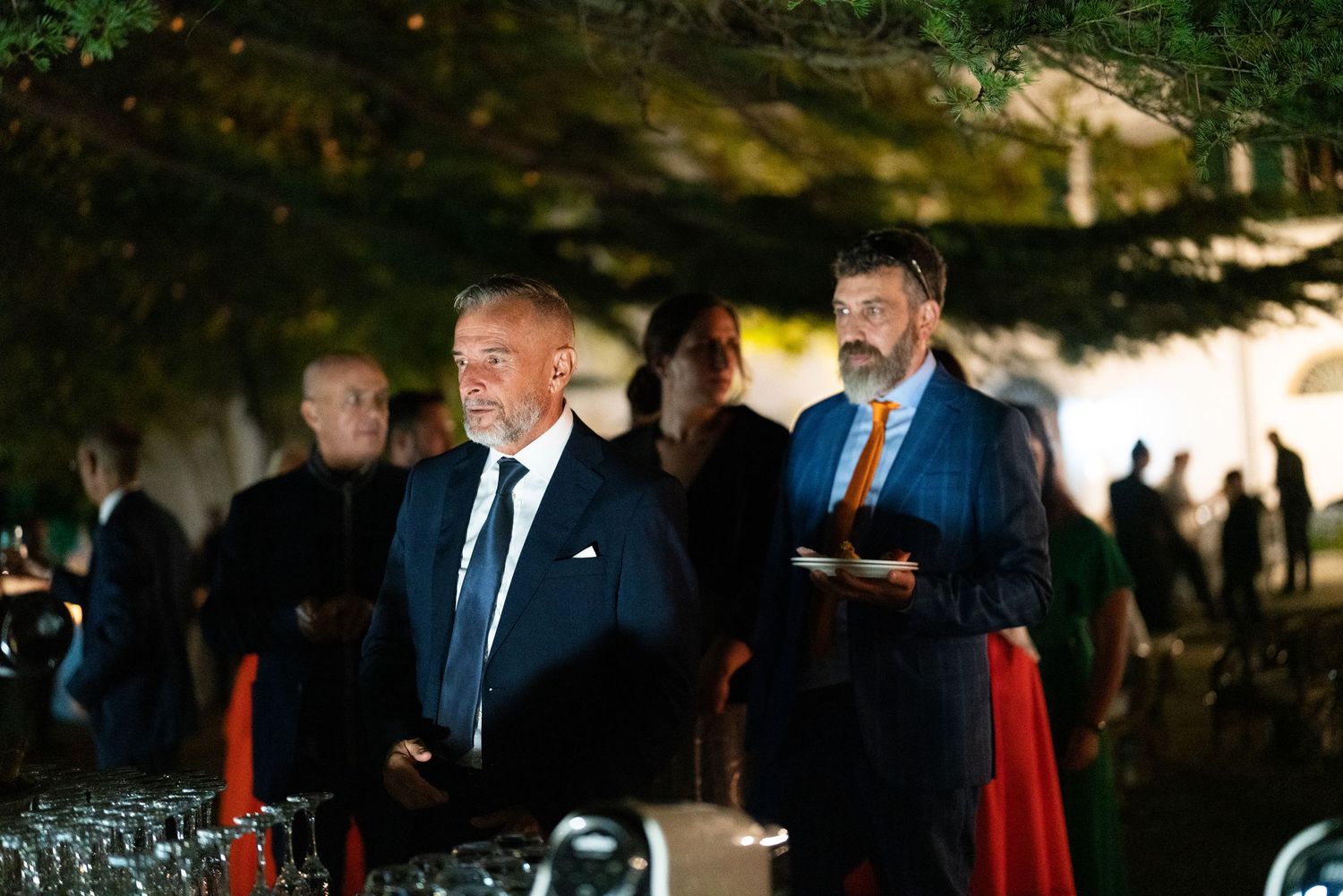 Wedding guests enjoying cocktail hour at an elegant outdoor venue.
