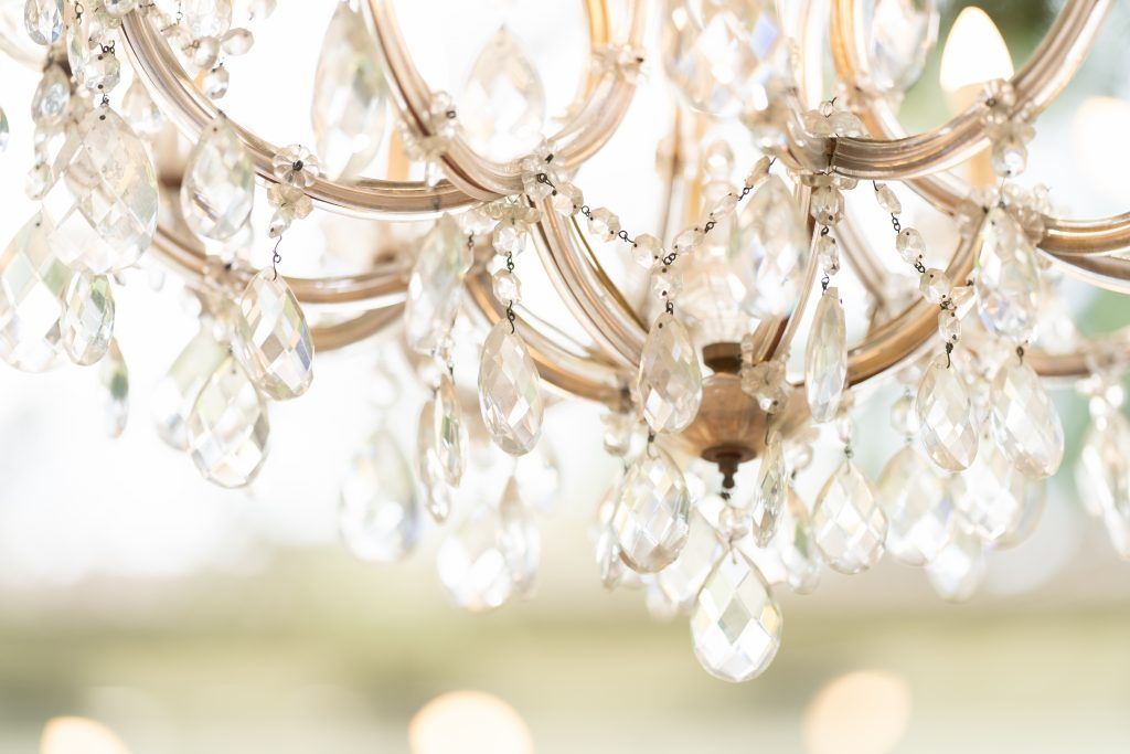 Crystal chandelier details with sparkling prisms and ornate metalwork.