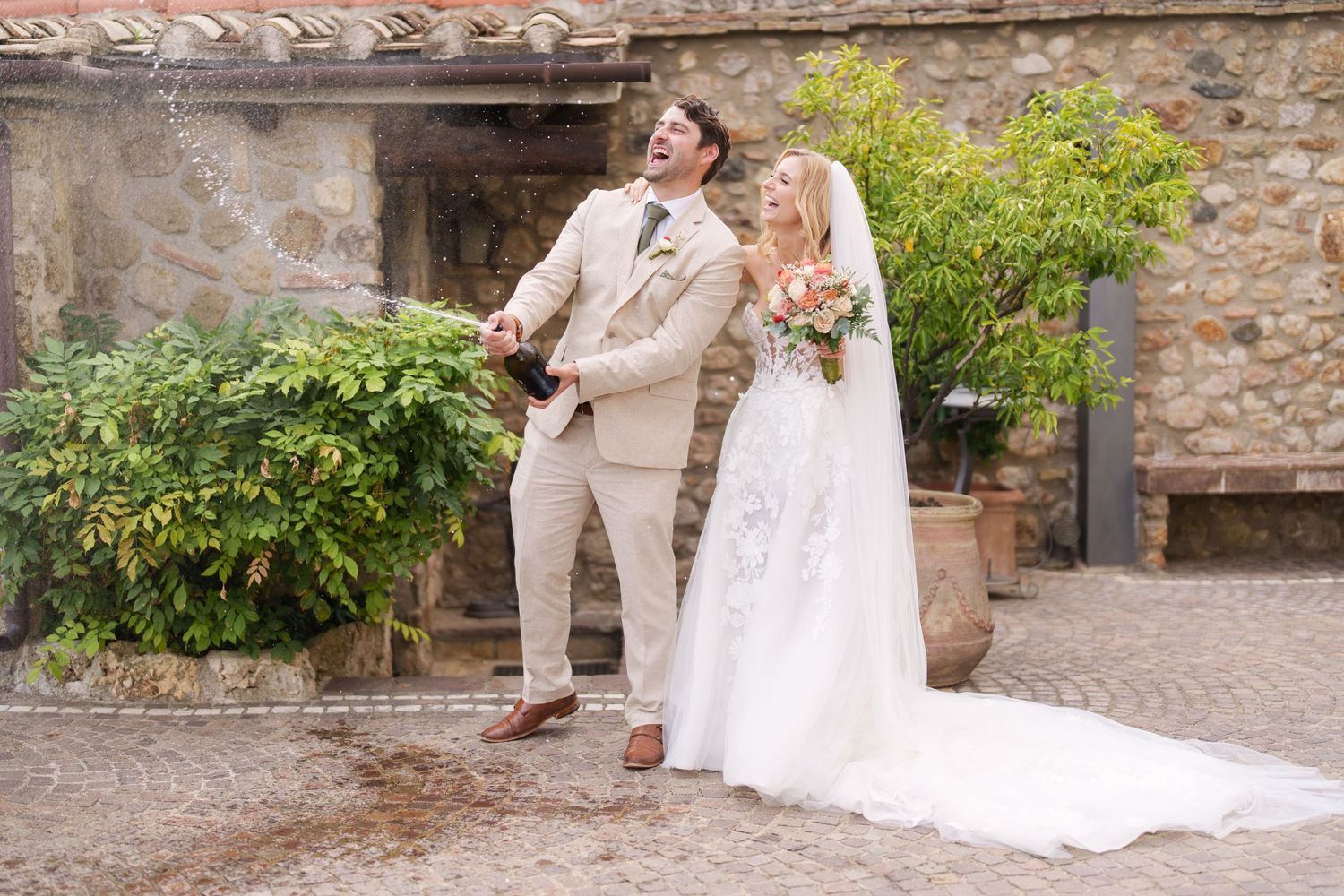 Elegant wedding photos showing joyful moments along a cobblestone path with greenery.