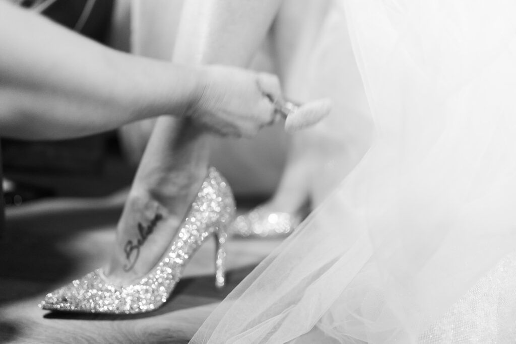 Close-up shots of a bride putting on sparkly wedding shoes and getting dressed for her special day.