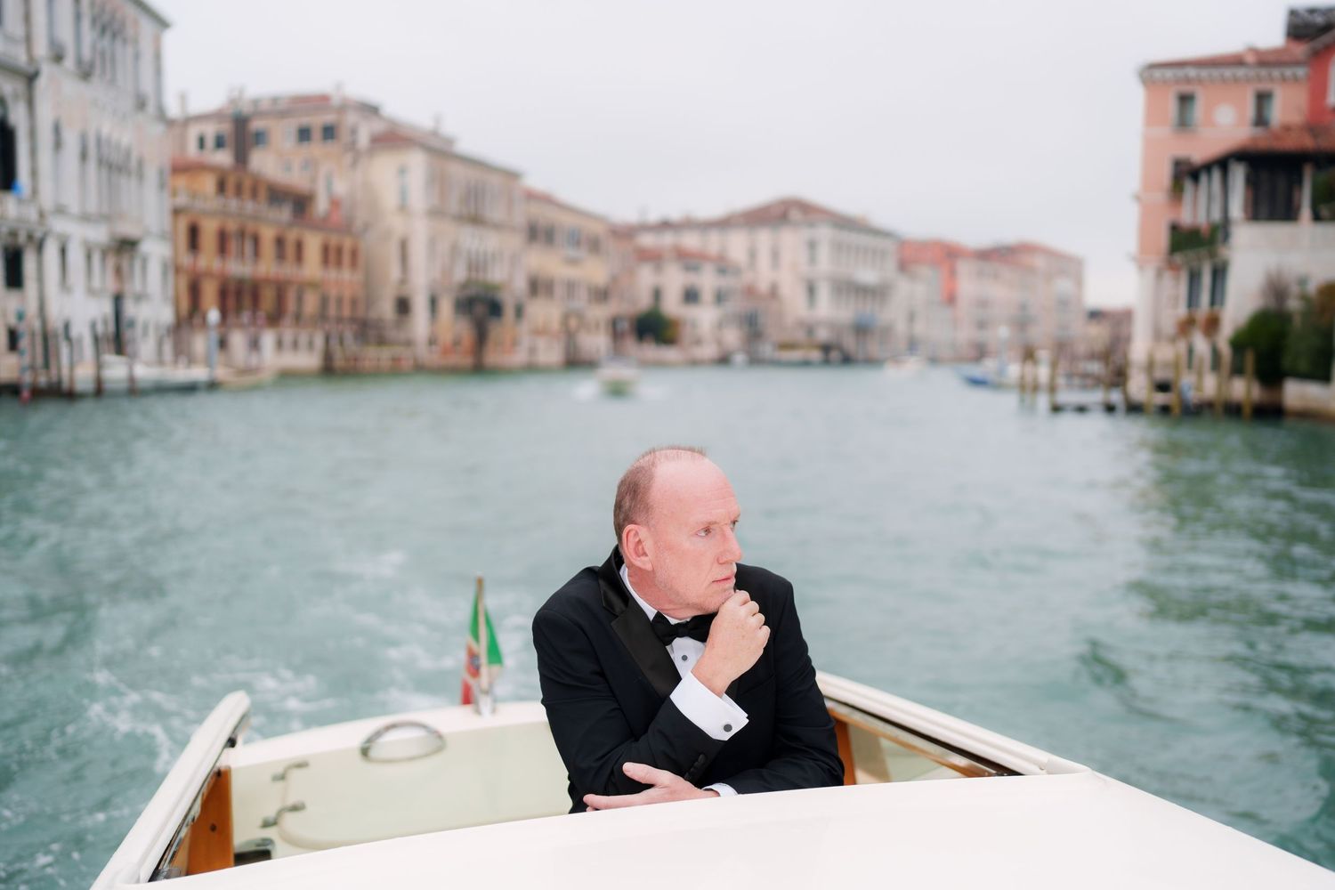 A series of photos showing a boat journey through the scenic canals of Venice with historic buildings along the waterway.