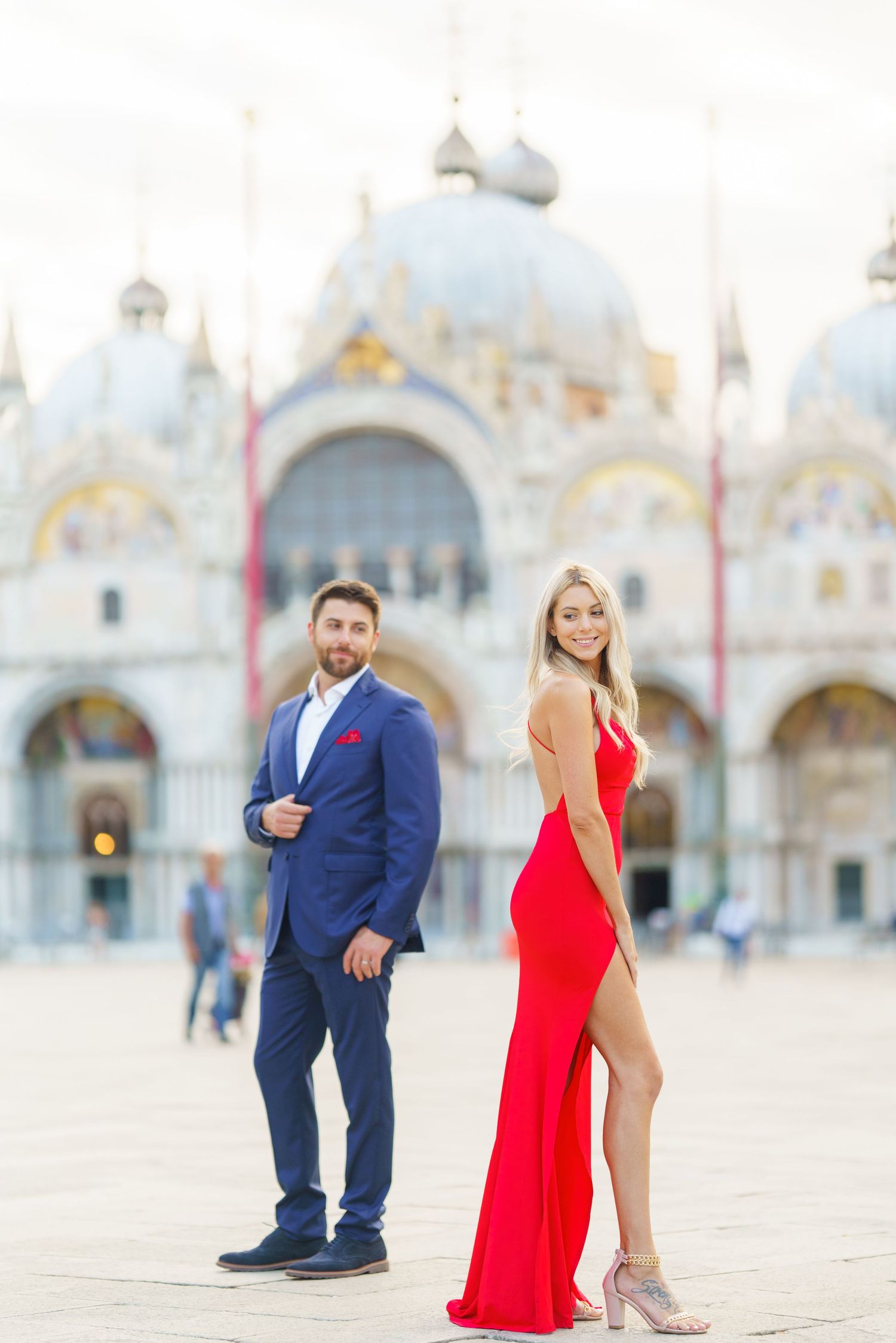 A couple in formal attire poses for romantic photos in Saint Mark's Square in Venice, Italy.