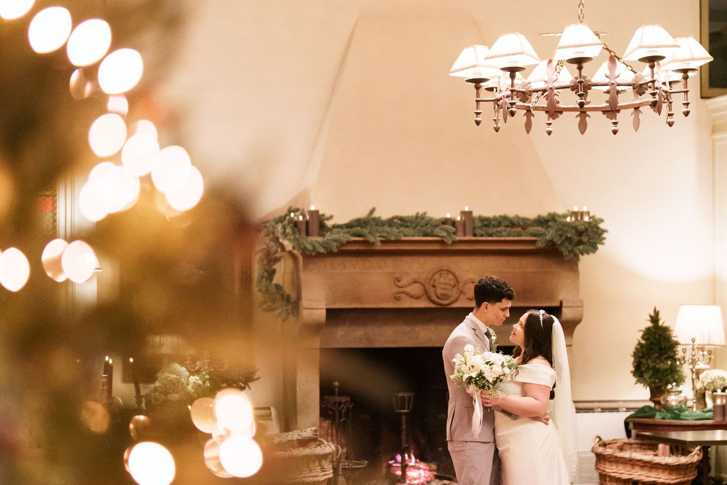 Warm glowing chandeliers and decorative lighting create ambiance in an elegant indoor venue.