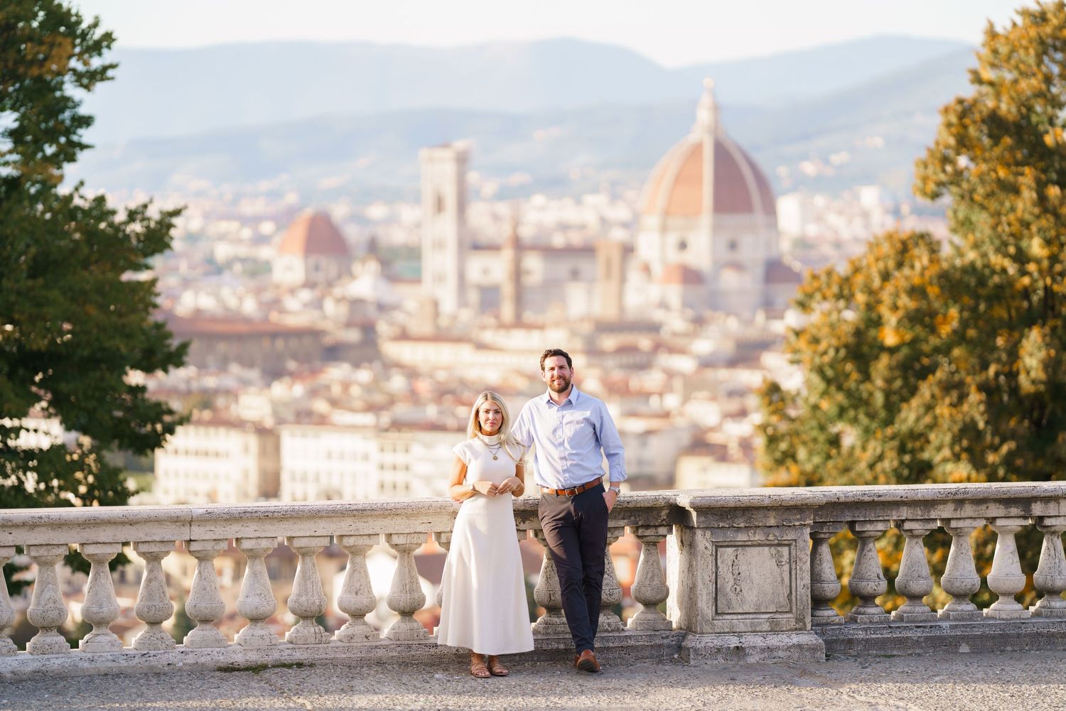 A romantic photoshoot overlooking the historic cityscape of Florence, Italy with the Duomo cathedral visible in background.