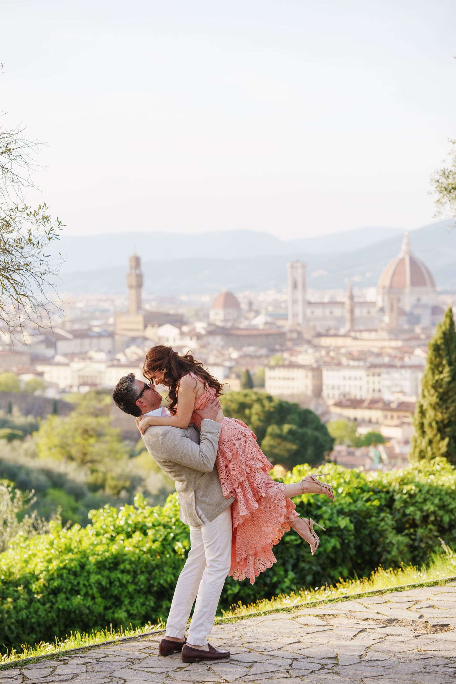 A romantic moment overlooking the iconic Florence skyline with the Duomo cathedral and historic architecture in the background.
