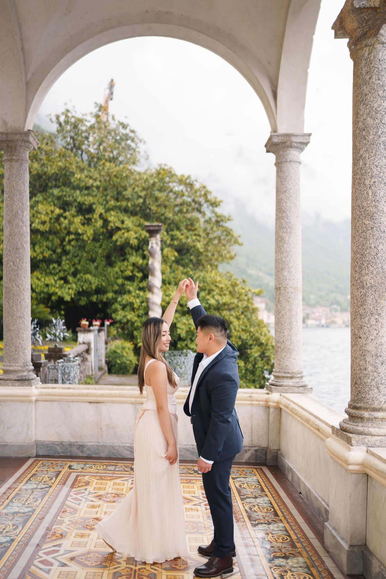 Lake Como proposal photographer capturing surprise engagement at Villa Monastero in Varenna