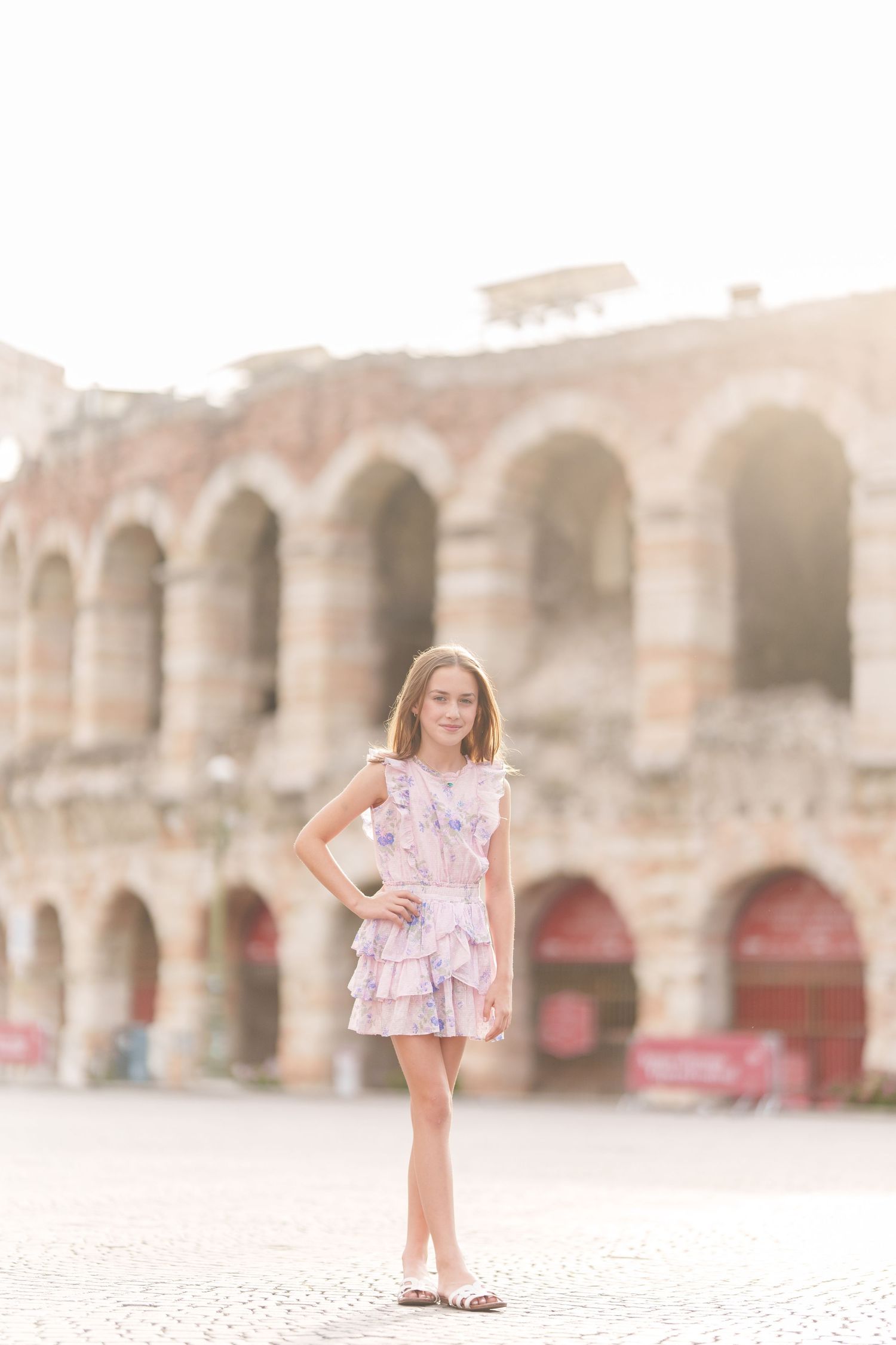 Verona family photographer family walking in front of Verona Arena Italy