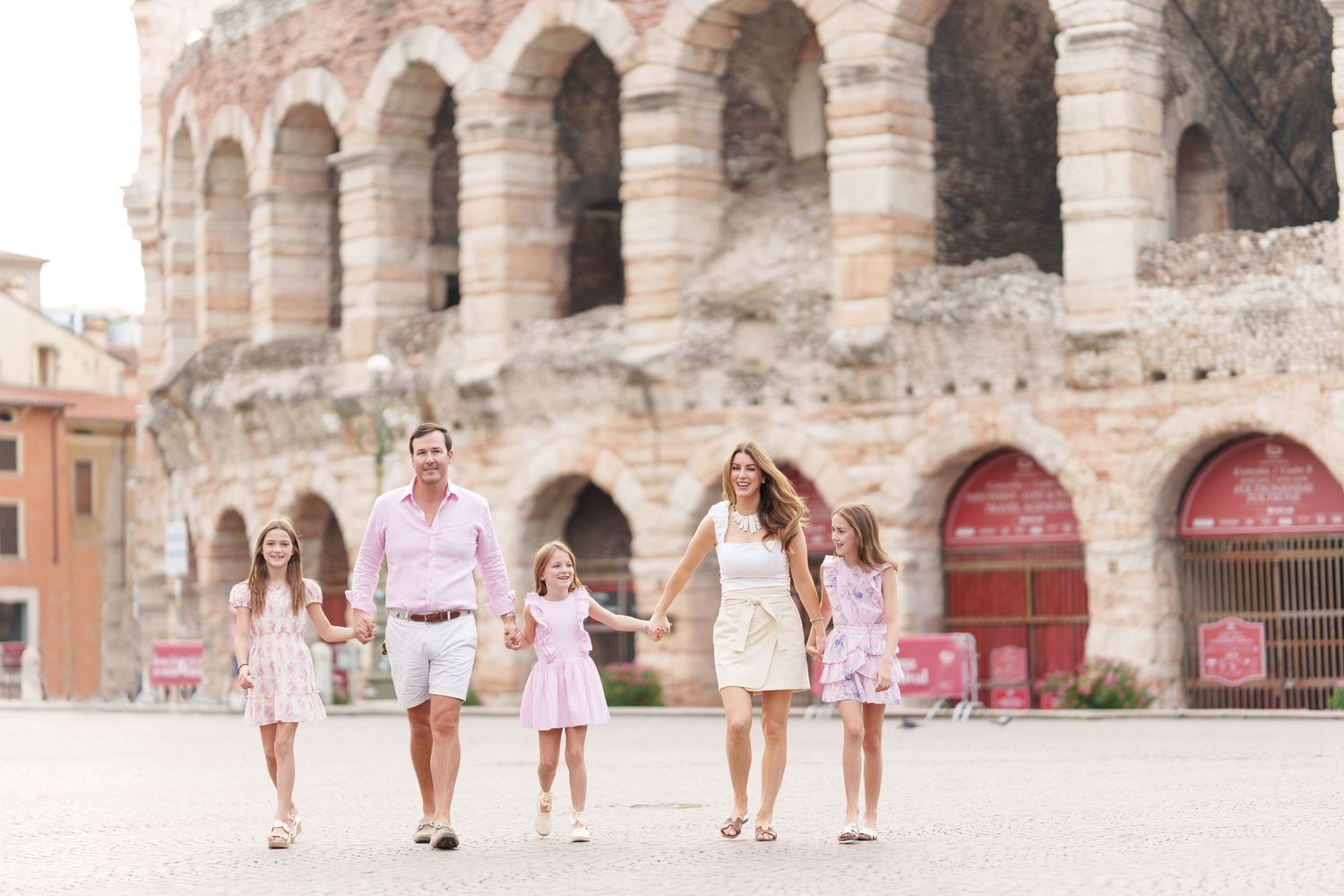 Verona family photographer family walking in front of Verona Arena Italy