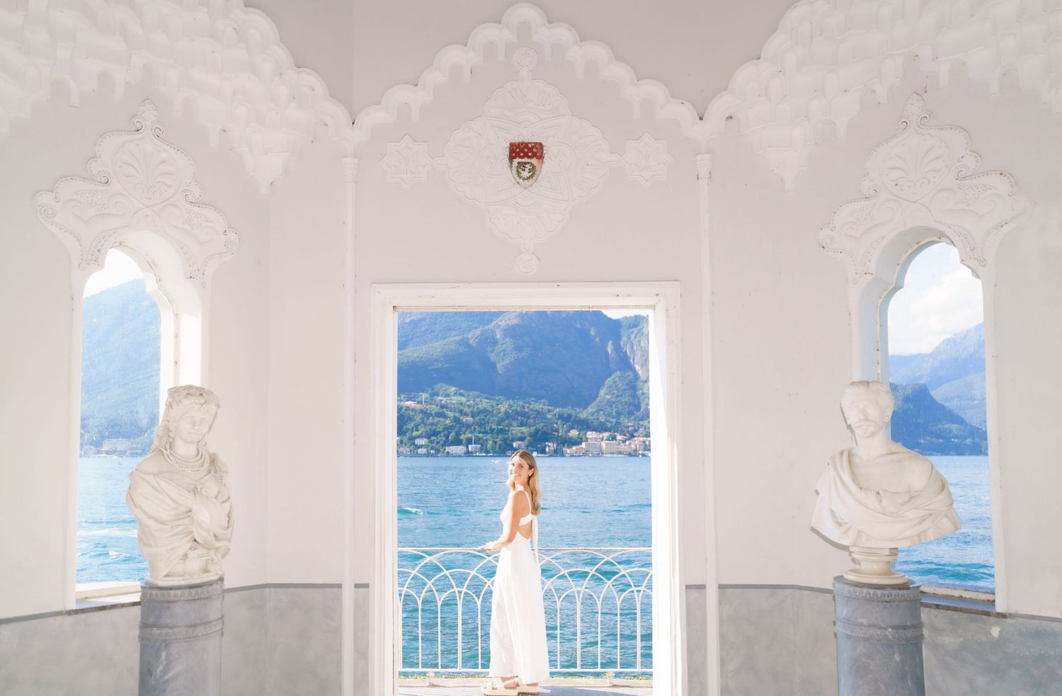 A series of scenic wedding photos showing a Mediterranean coastal venue with white arches and blue ocean views.