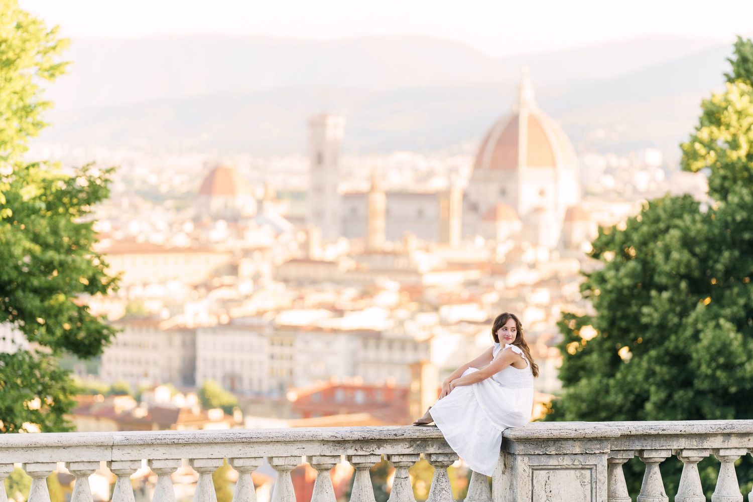 A panoramic view of Florence, Italy with the iconic Duomo cathedral dome rising above the historic cityscape.