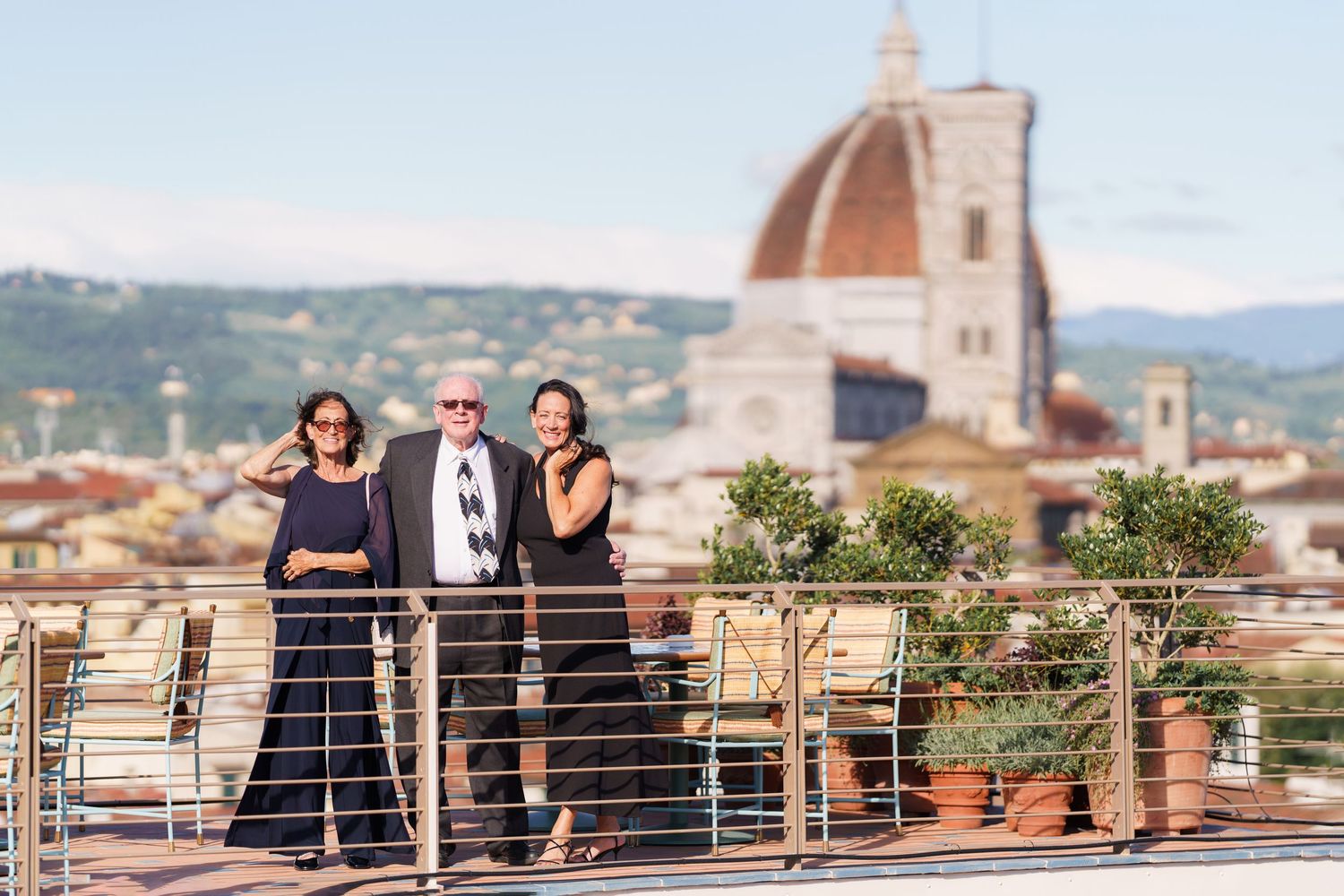 Friends enjoying rooftop views of Florence's historic skyline and Duomo.