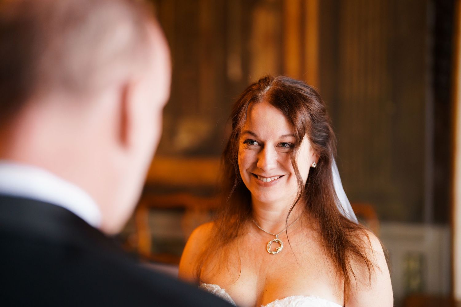 A couple shares a romantic moment during their first dance at a wedding reception in a rustic venue.