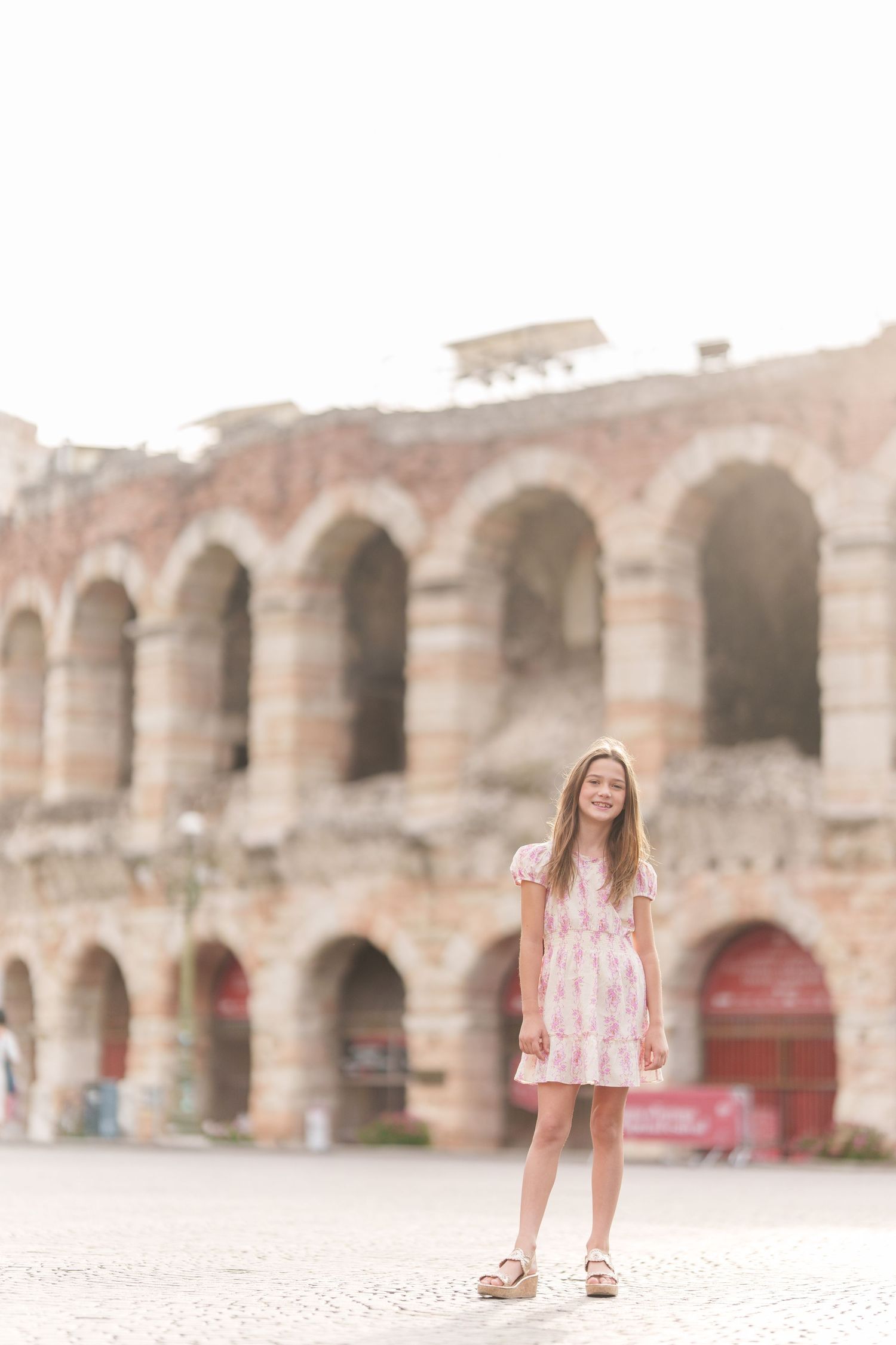 Verona family photographer family walking in front of Verona Arena Italy
