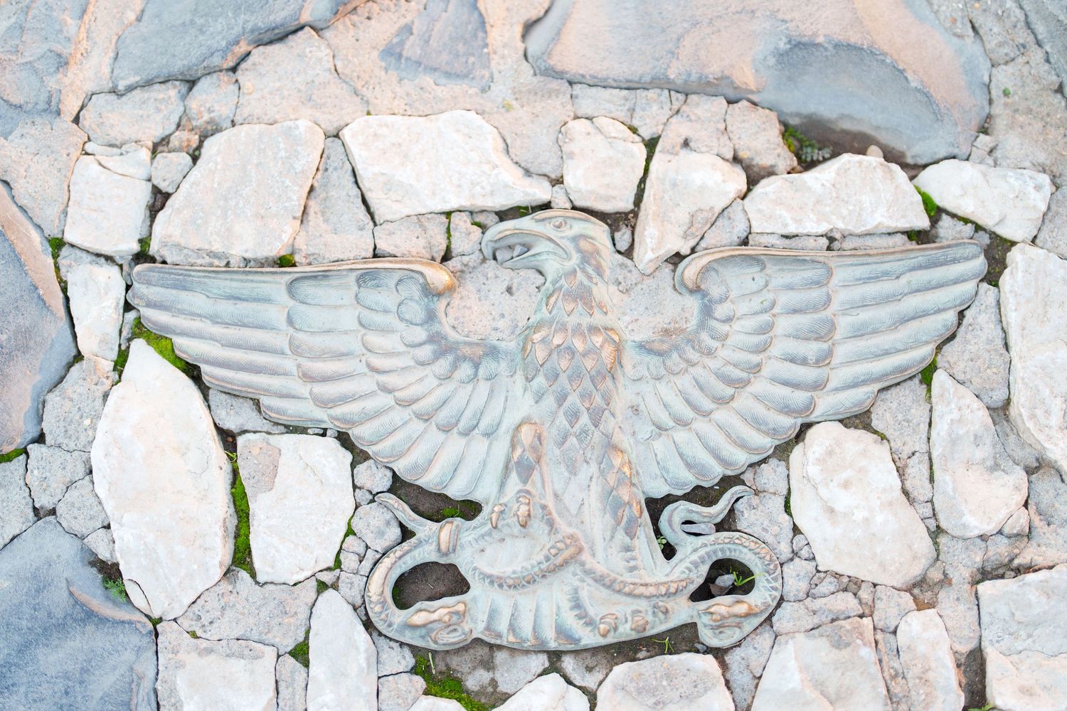 Stone carving of an eagle detail on ancient Roman architecture.