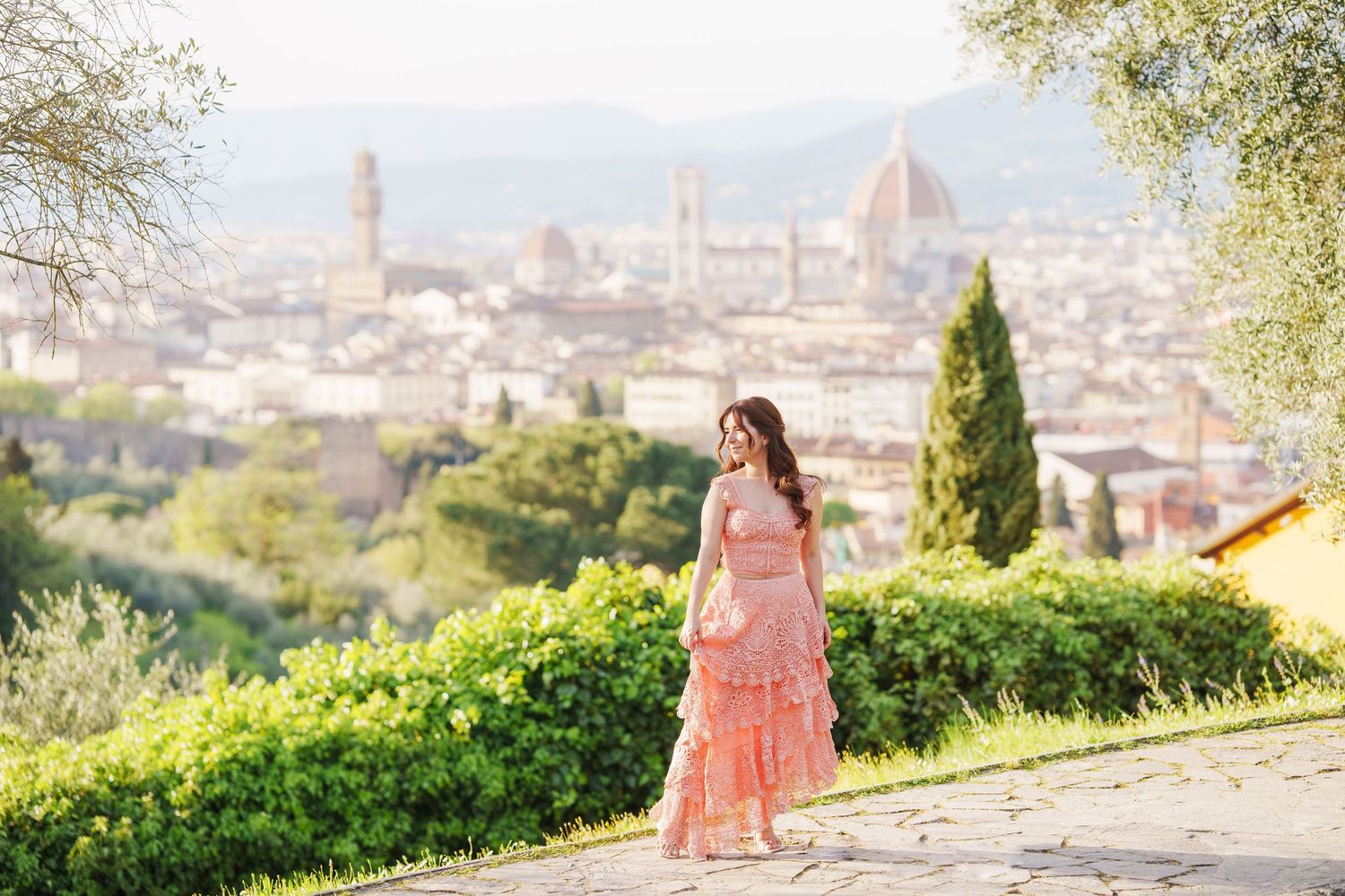 A scenic view of Florence, Italy with the iconic Duomo cathedral and cityscape visible in the background.