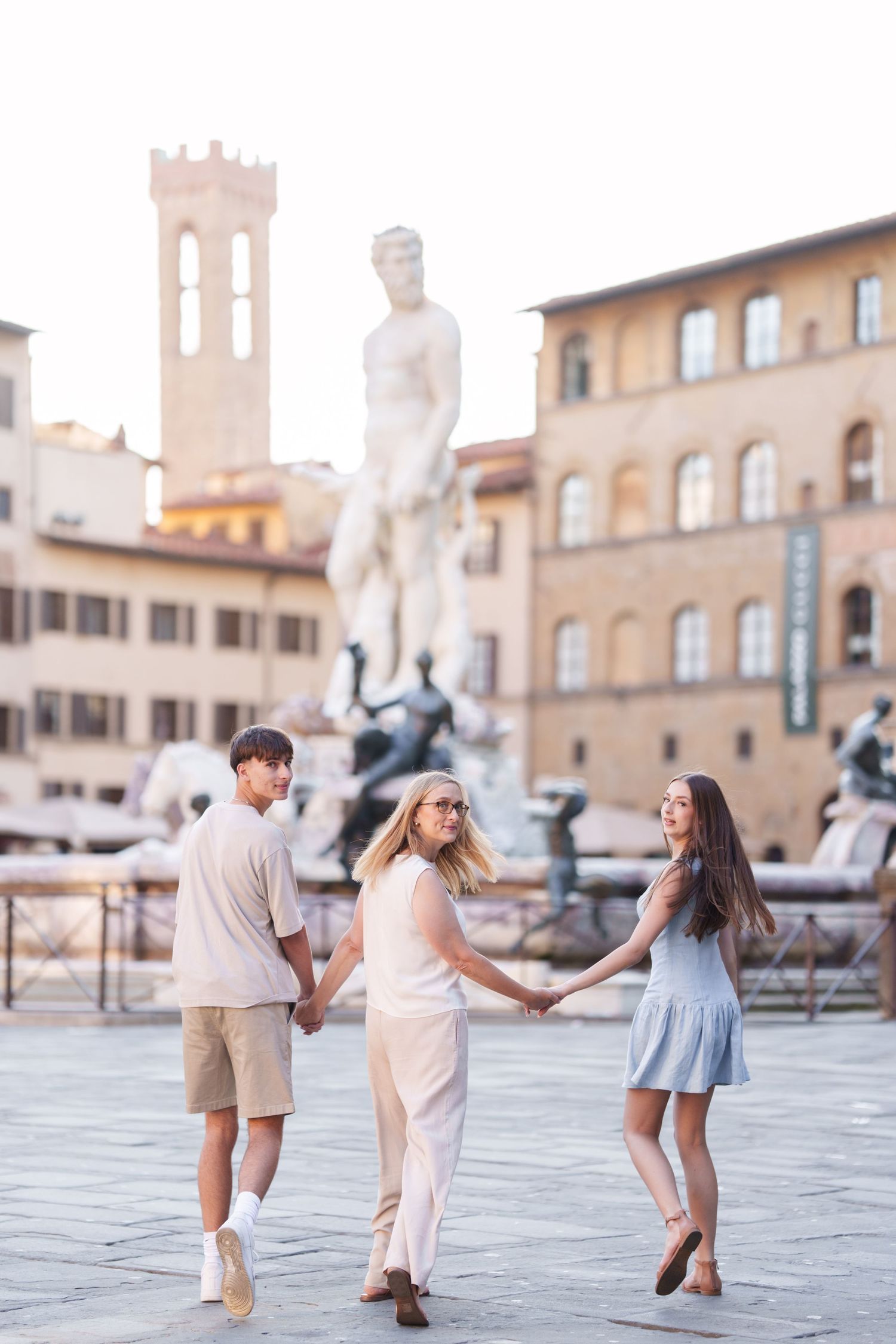 Couple dancing and twirling together in a romantic photoshoot at Piazza della Signoria in Florence, Italy.