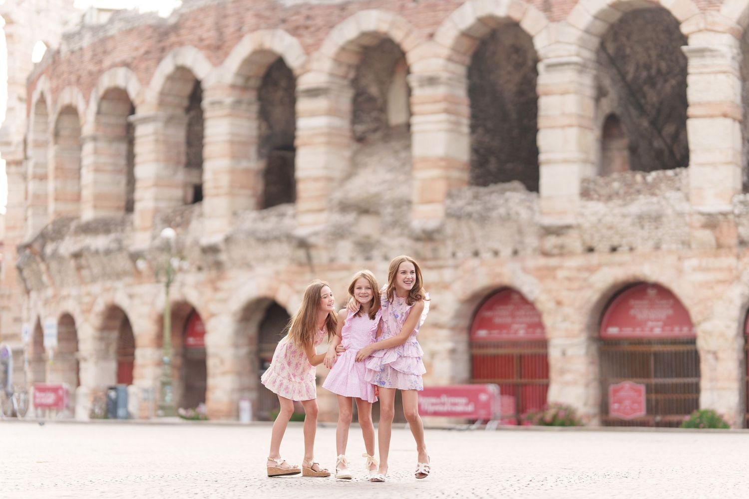 Verona family photographer family walking in front of Verona Arena Italy
