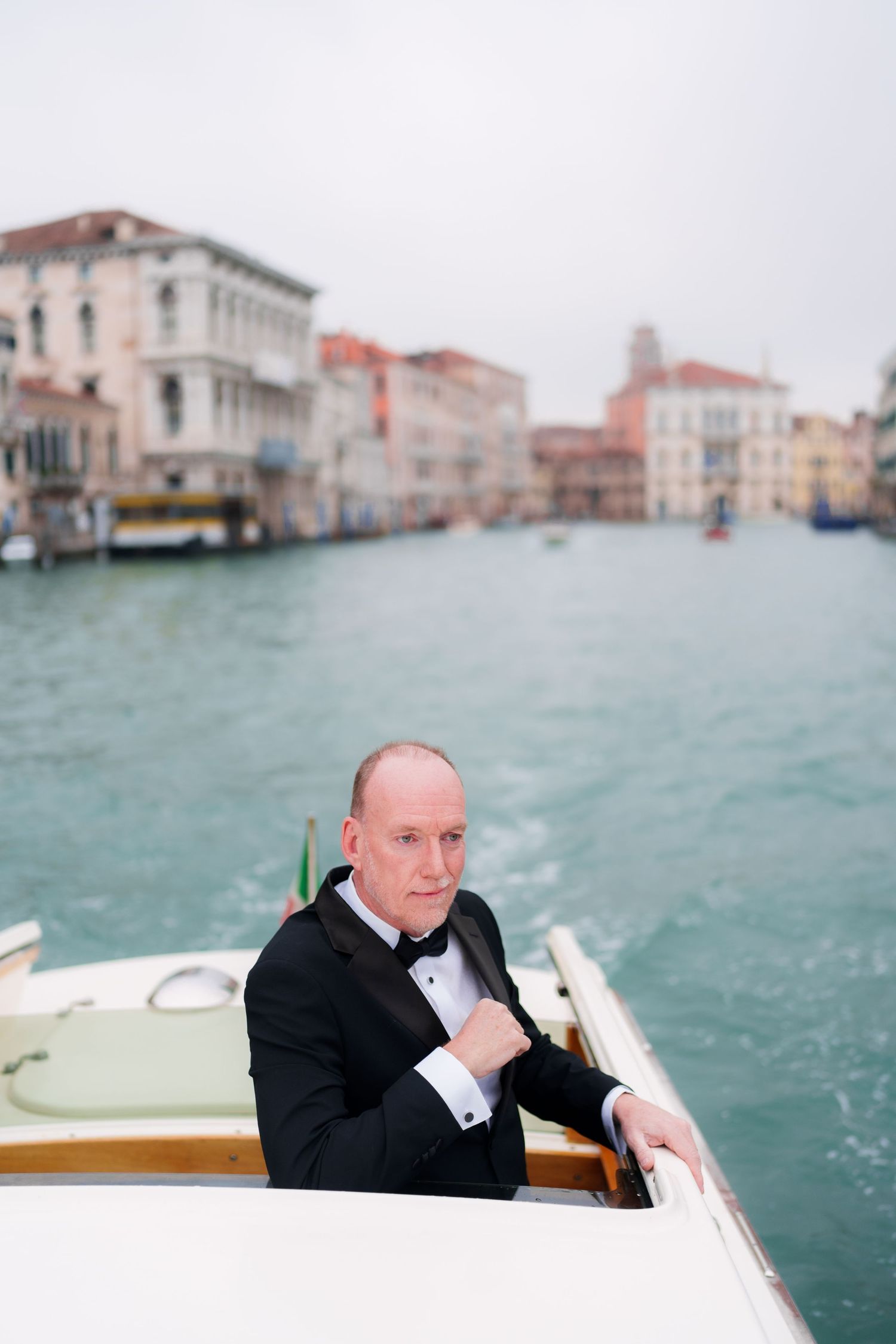 Series of photos showing a water taxi ride through Venice's Grand Canal with historic buildings in the background.