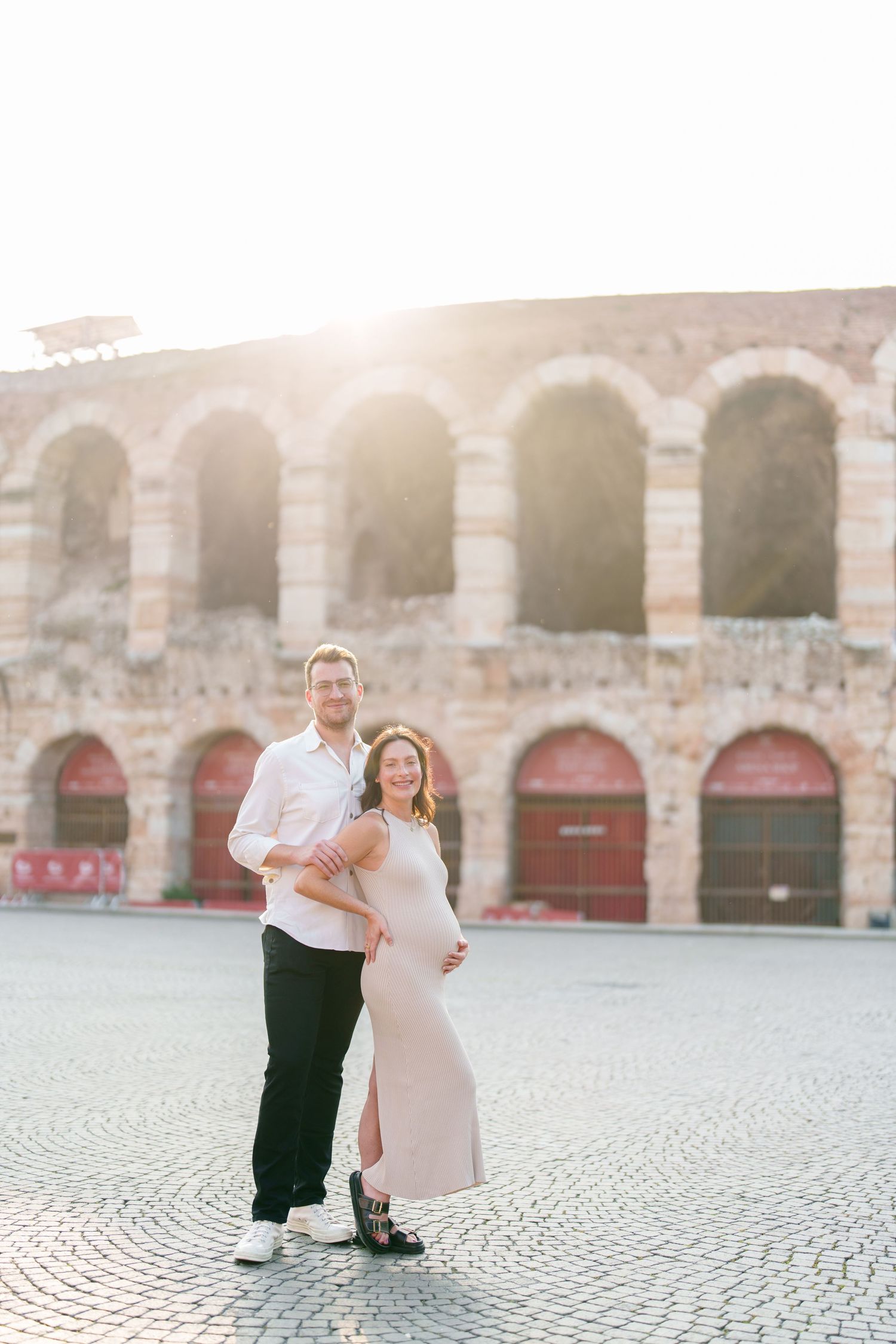 Verona photographer A couple poses romantically in front of the historic Verona Arena in Italy during sunset.