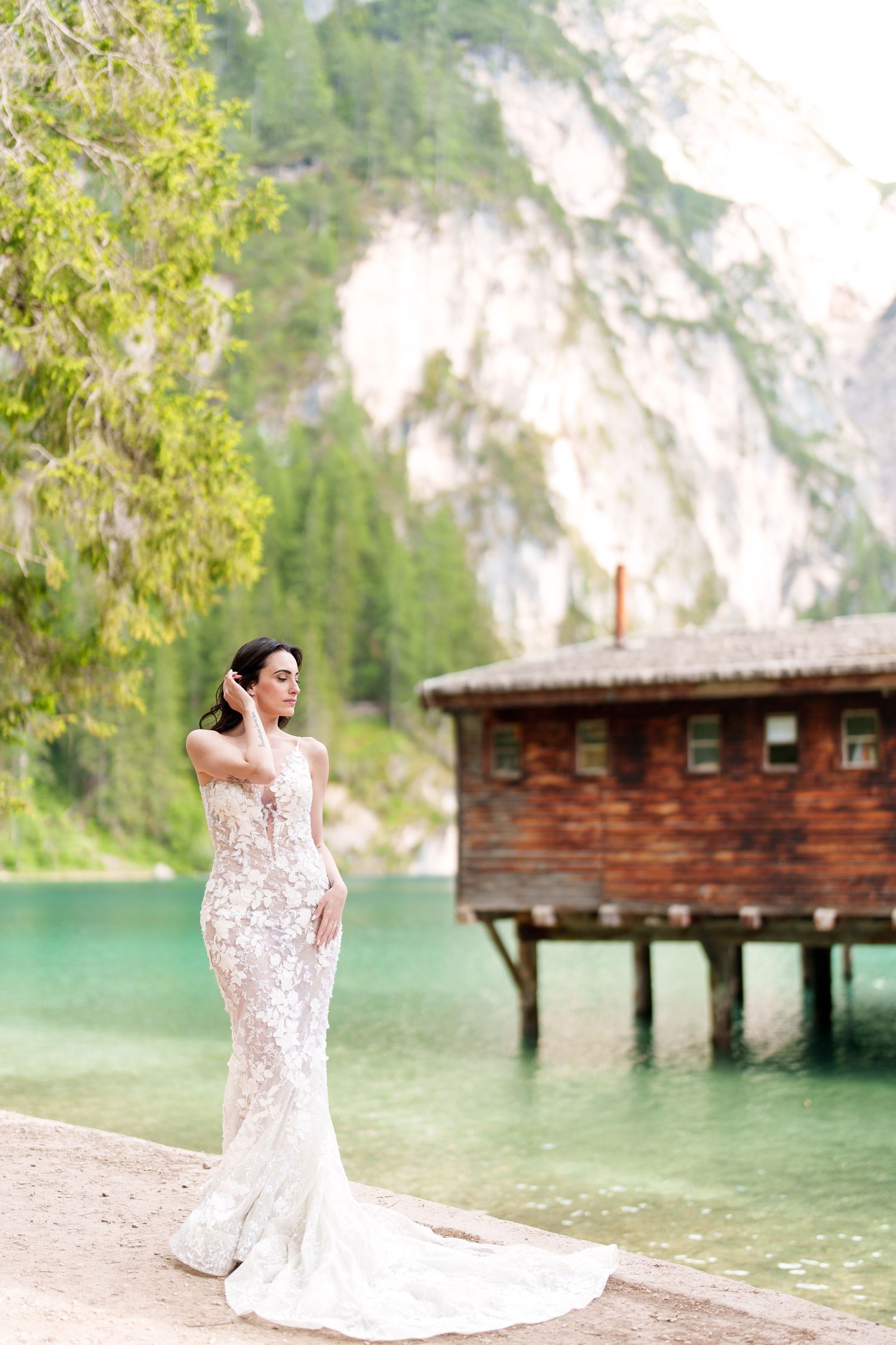 Scenic lakeside boathouse with wooden pier and mountain backdrop at a tranquil alpine lake.