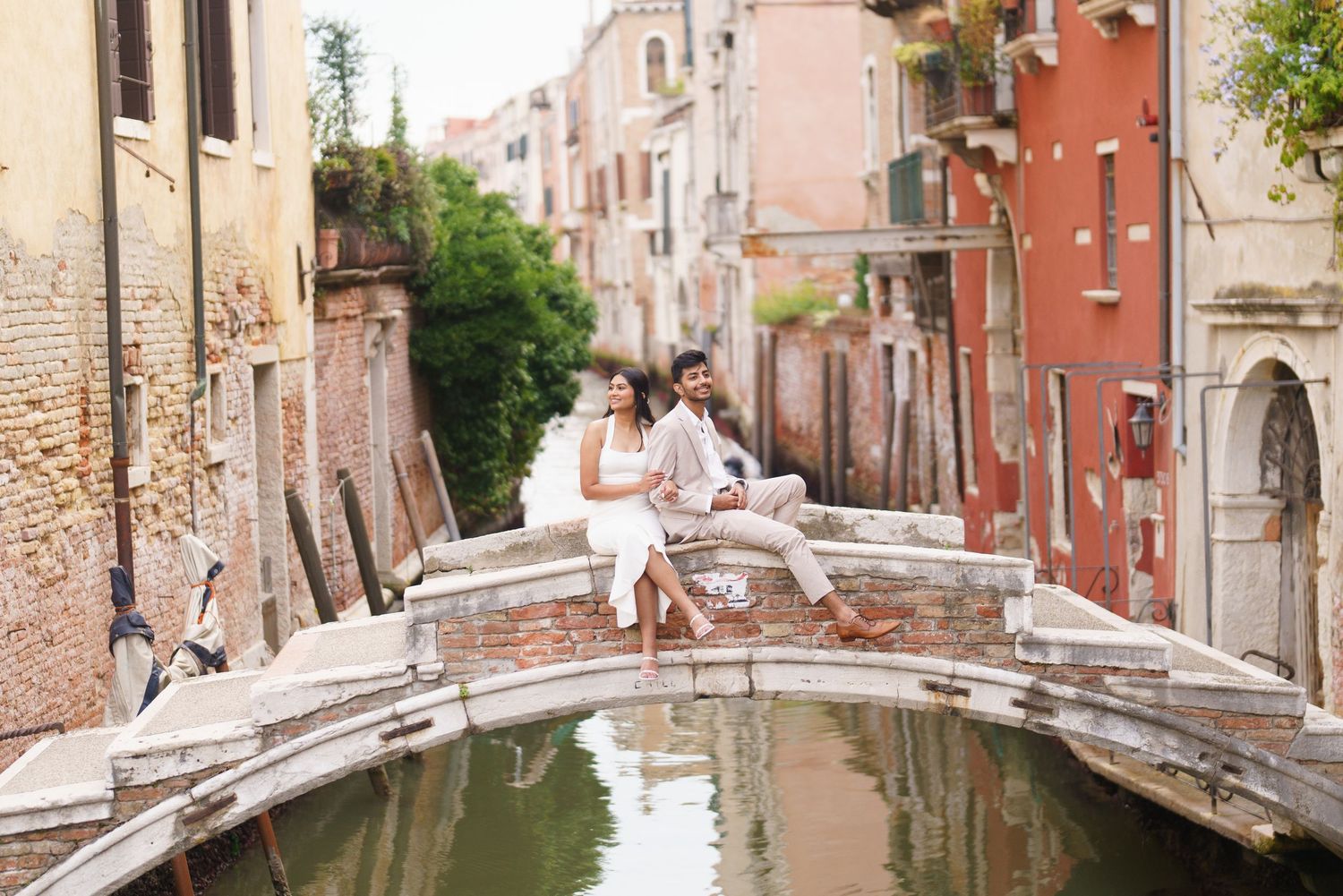 Scenic view of a narrow canal in Venice with historic buildings and traditional architecture along the waterway.