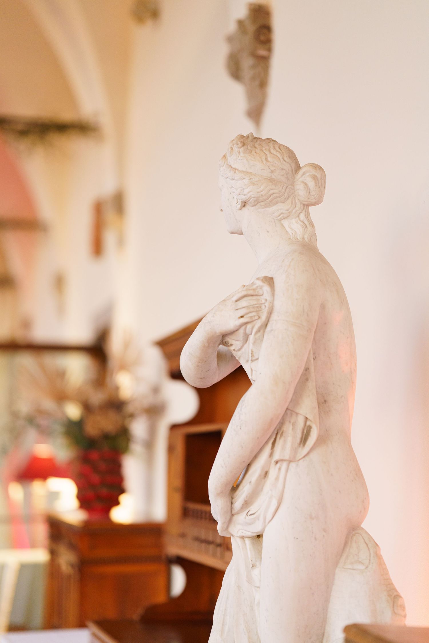 White classical statues displayed in an indoor venue setting.