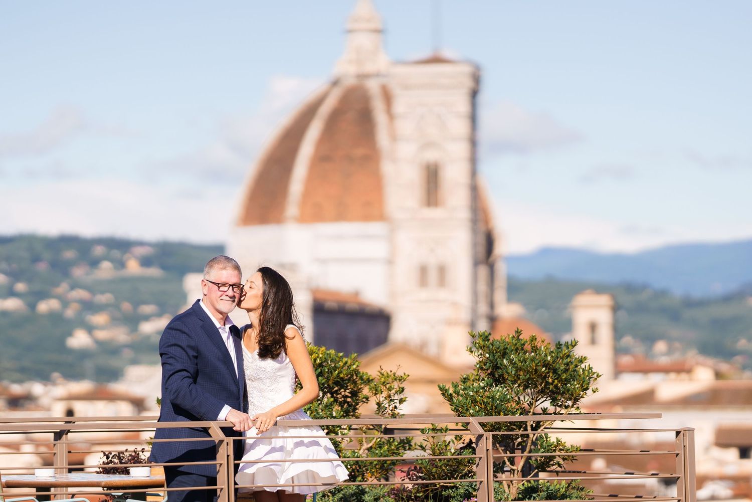 Rooftop terrace overlooking Florence's historic Duomo cathedral and cityscape.