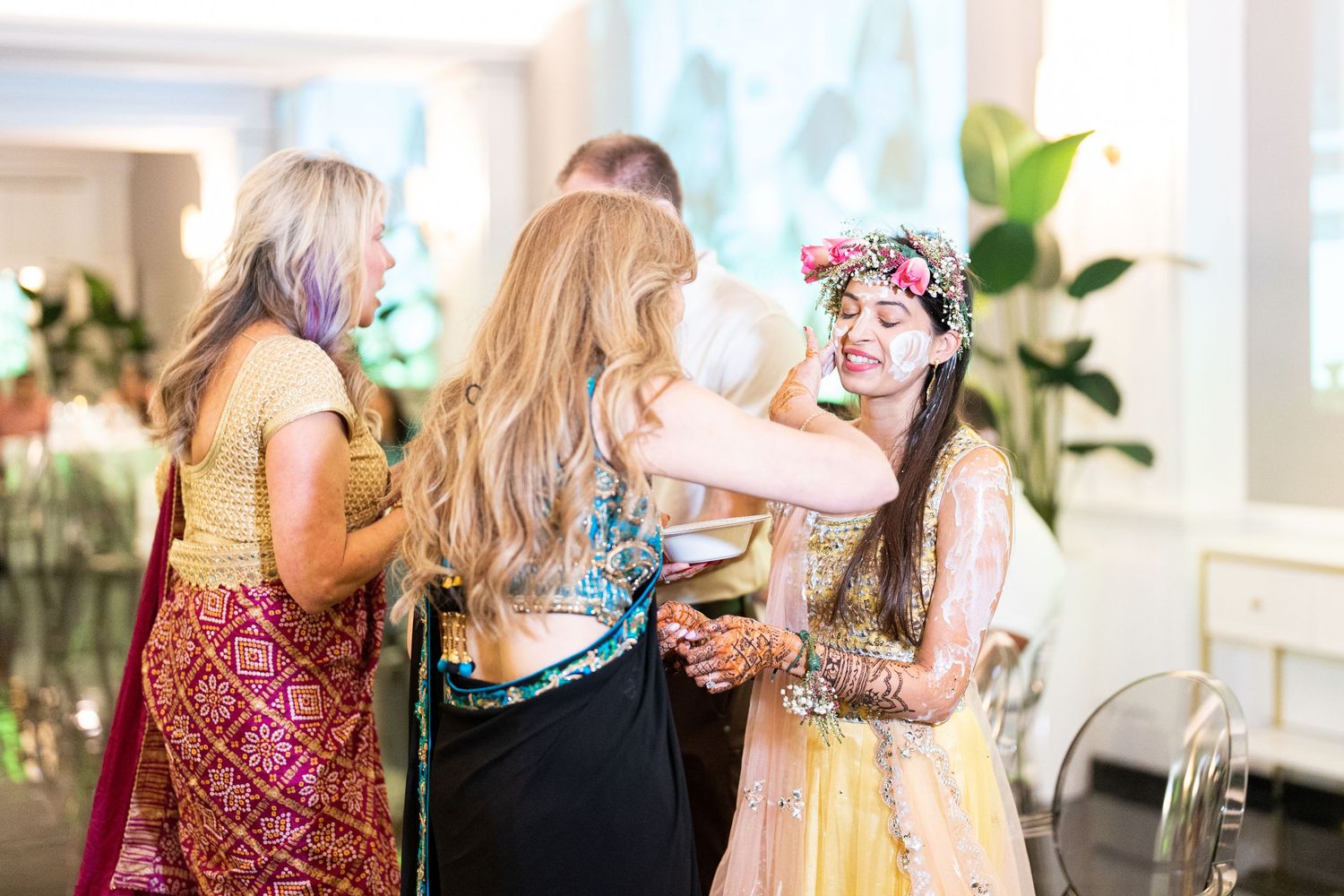 A group gathers at a bright indoor celebration with festive decor.