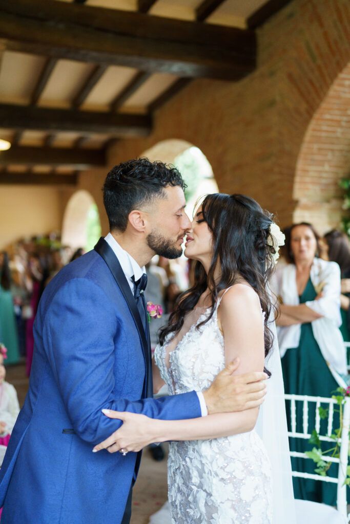 Newlyweds share their first kiss as husband and wife during an intimate wedding ceremony.