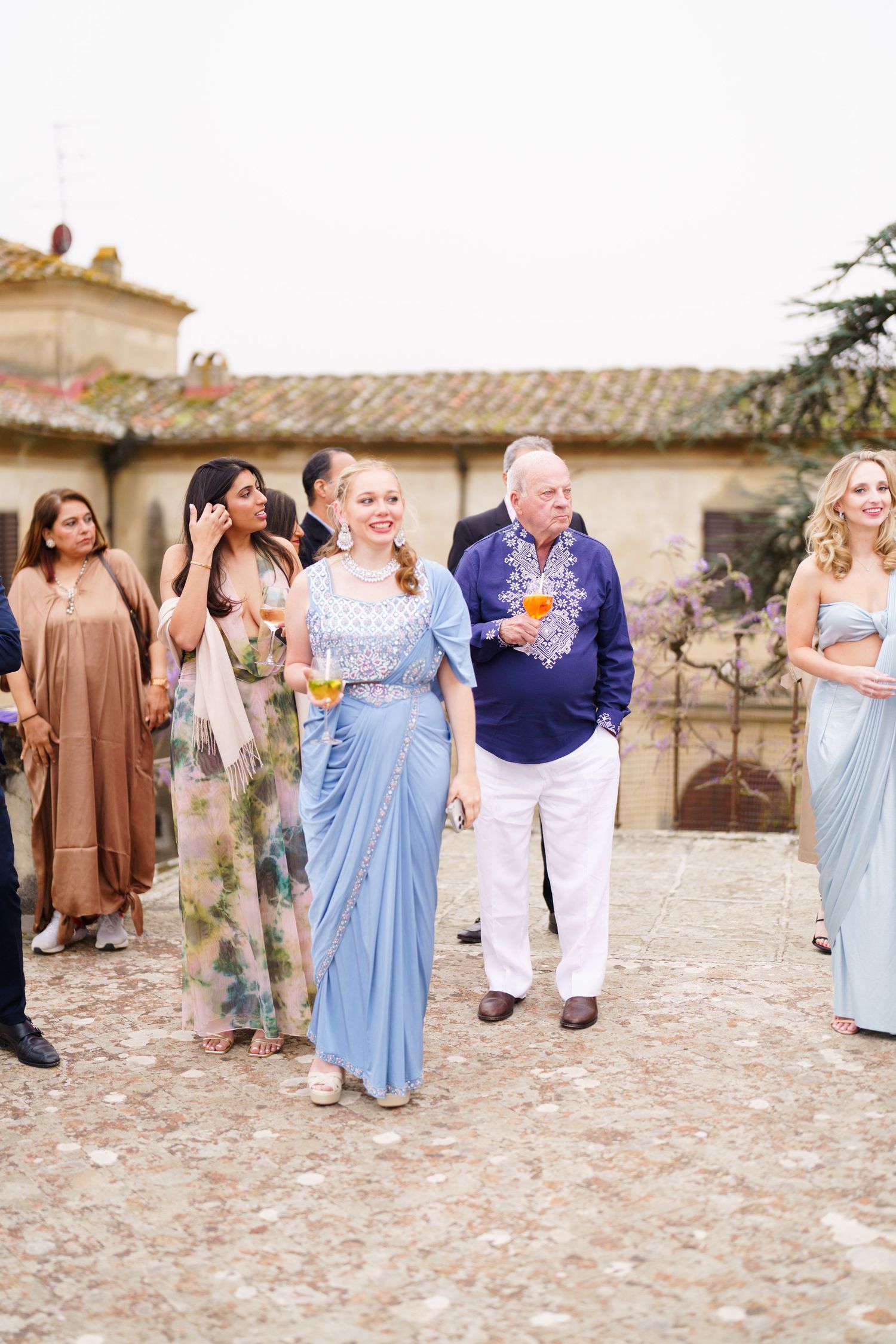 Guests enjoying cocktails and conversation during an outdoor wedding reception.